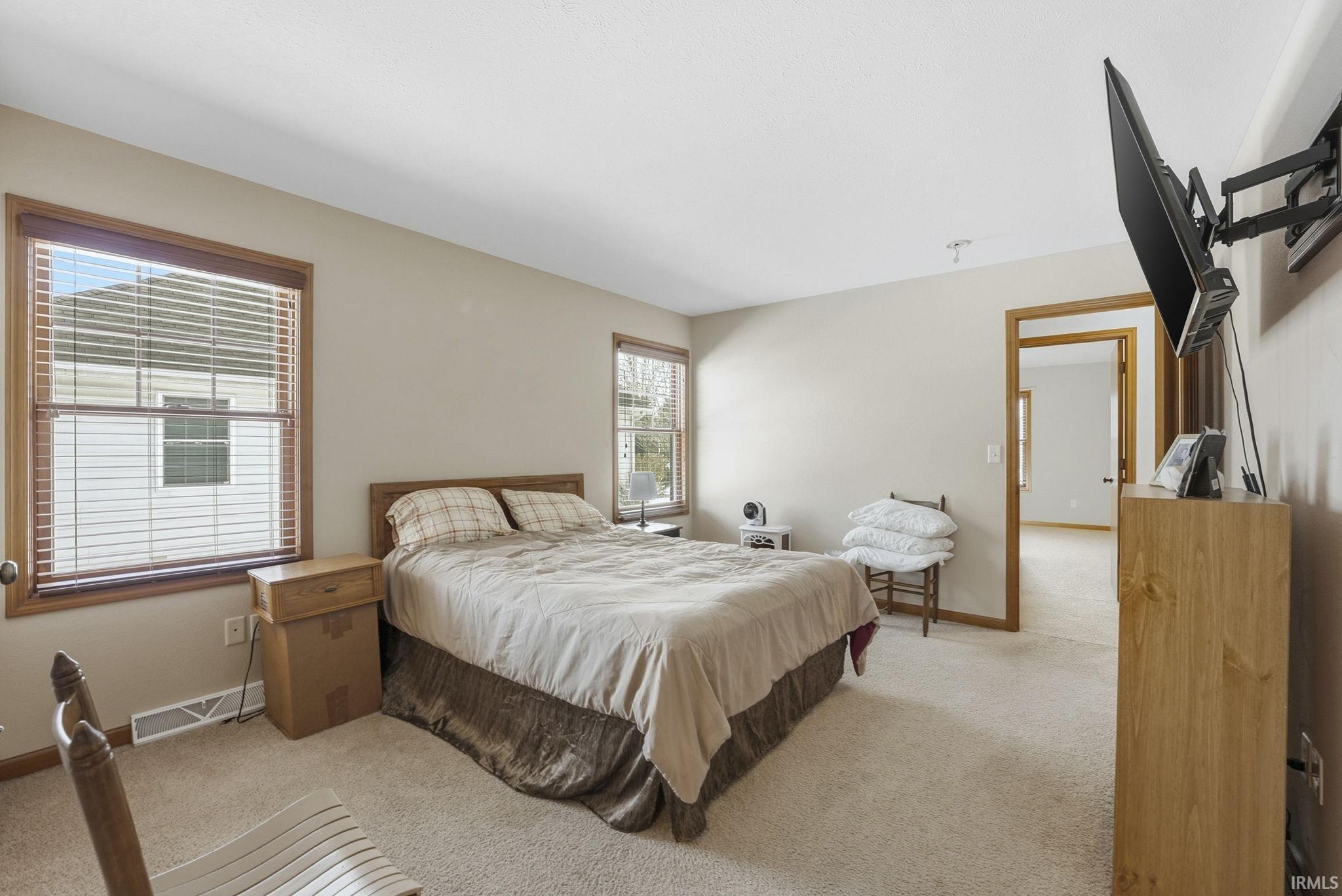 Bedroom with light colored carpet