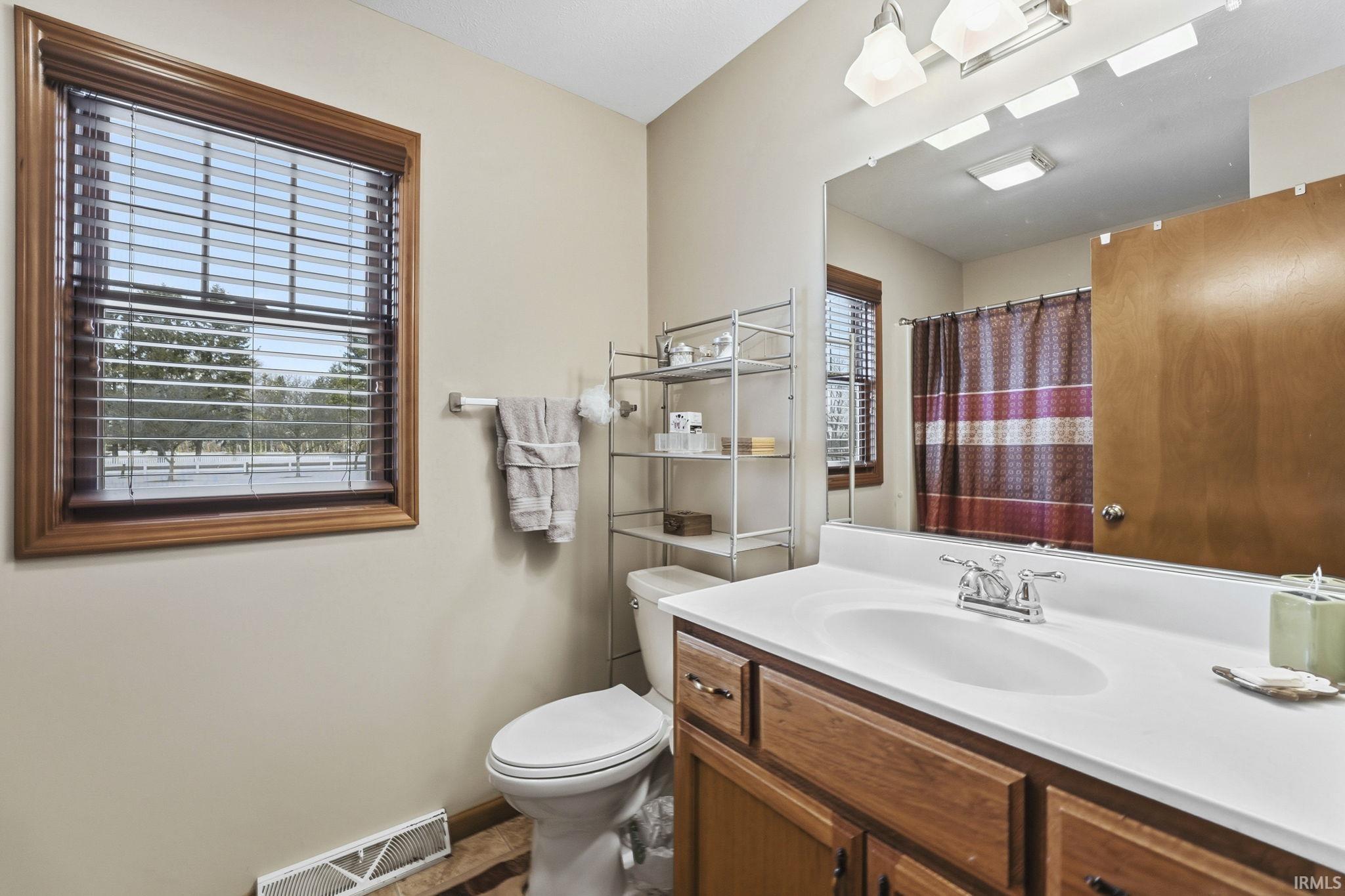 Full bathroom with a shower with curtain and vanity