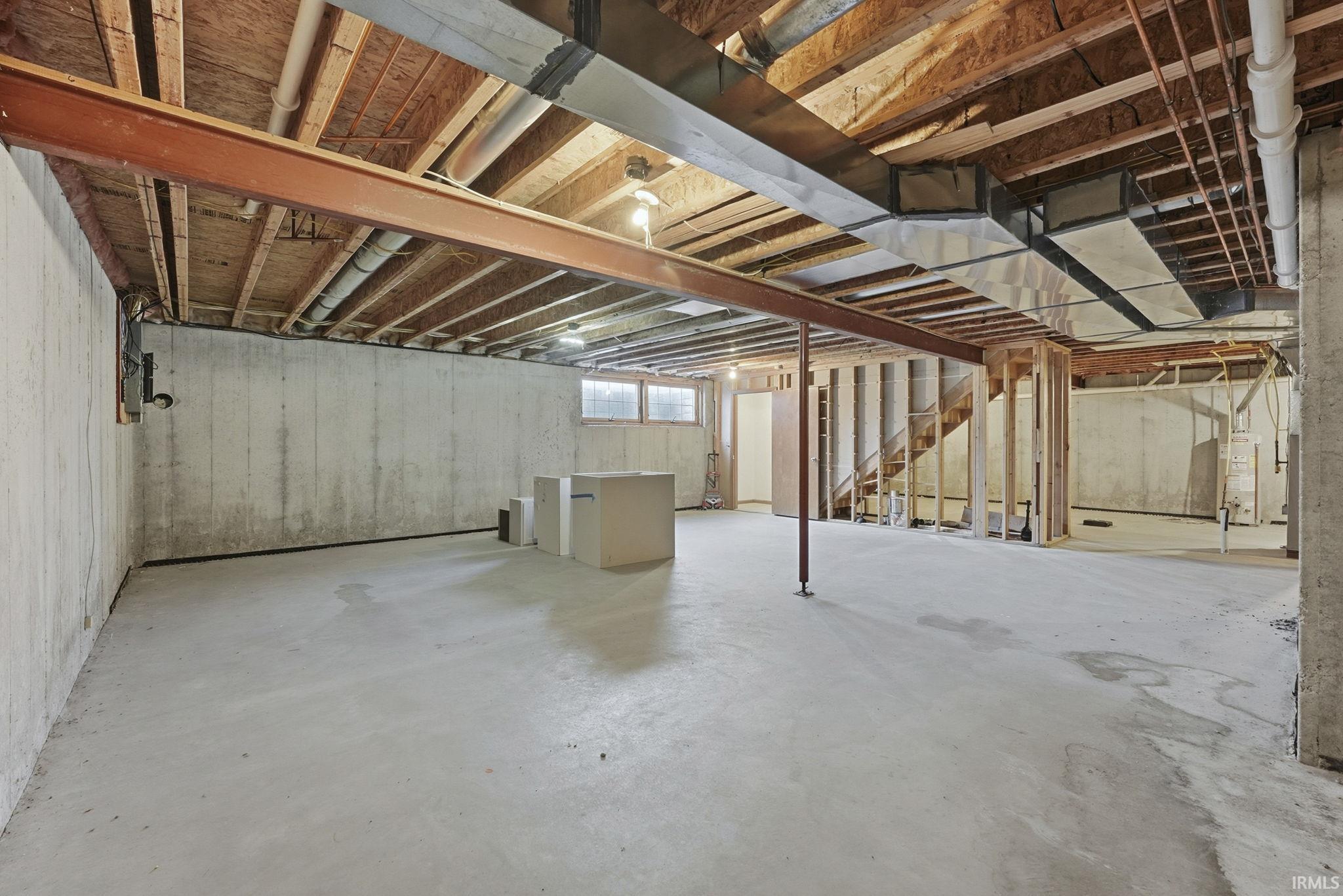 Below grade area with water heater and stairs