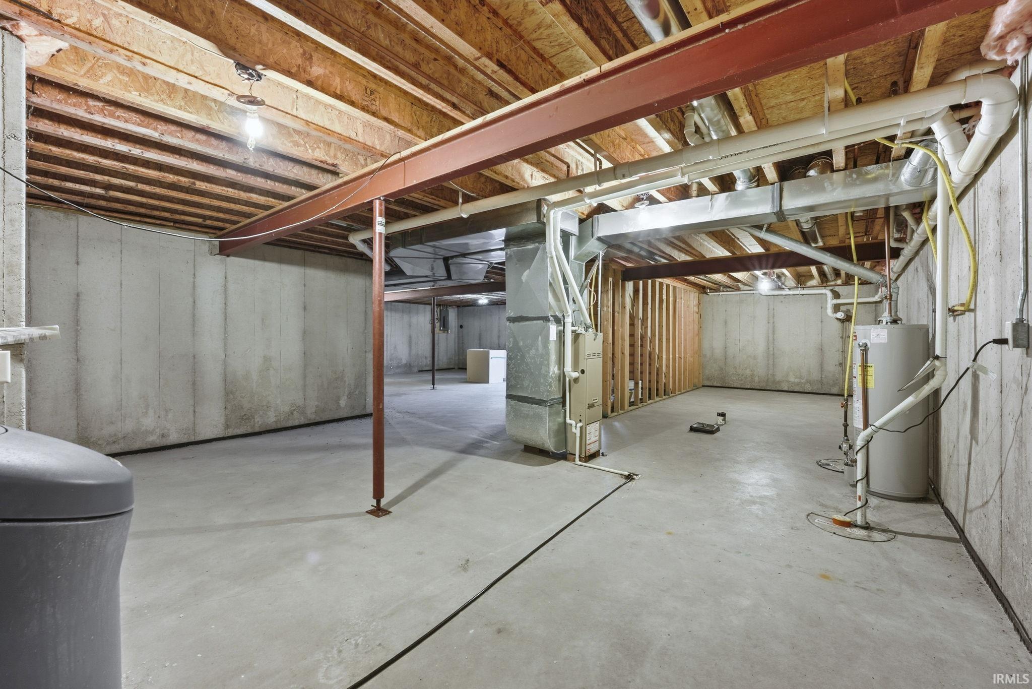 Unfinished below grade area with heating unit and water heater