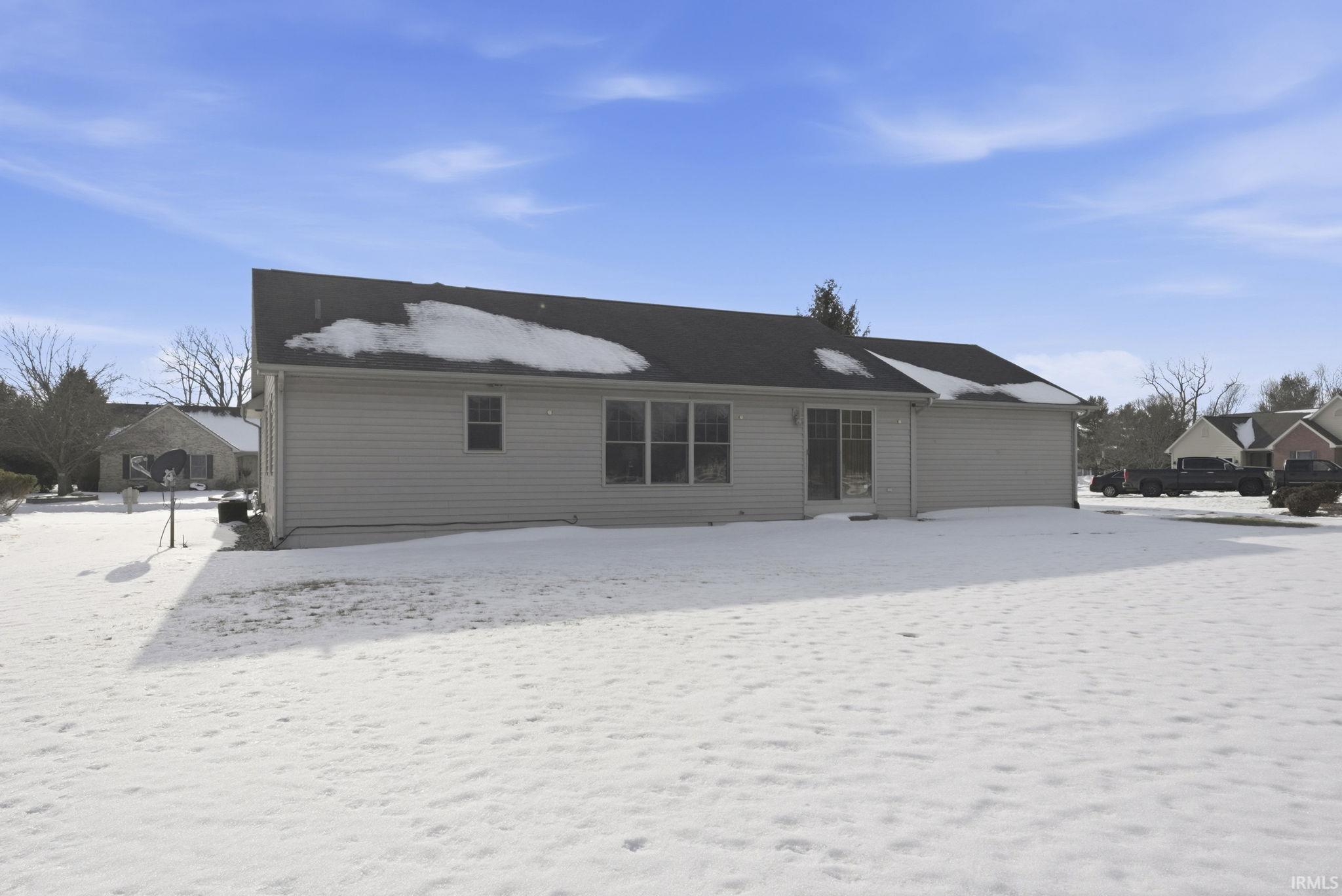 View of snow covered rear of property