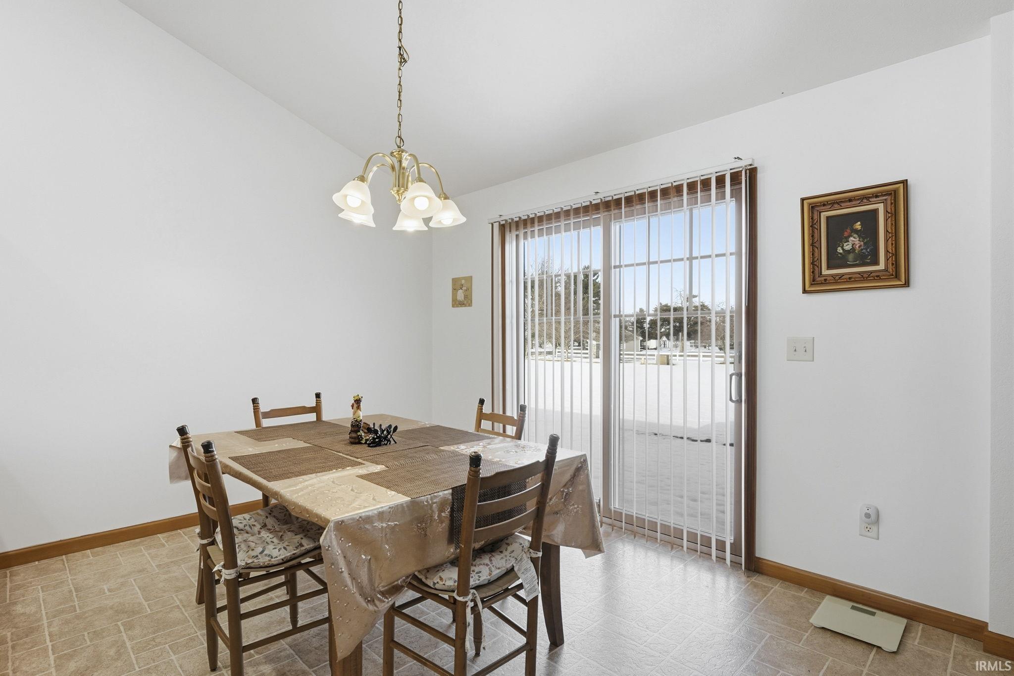Dining space featuring vaulted ceiling and hanging lights