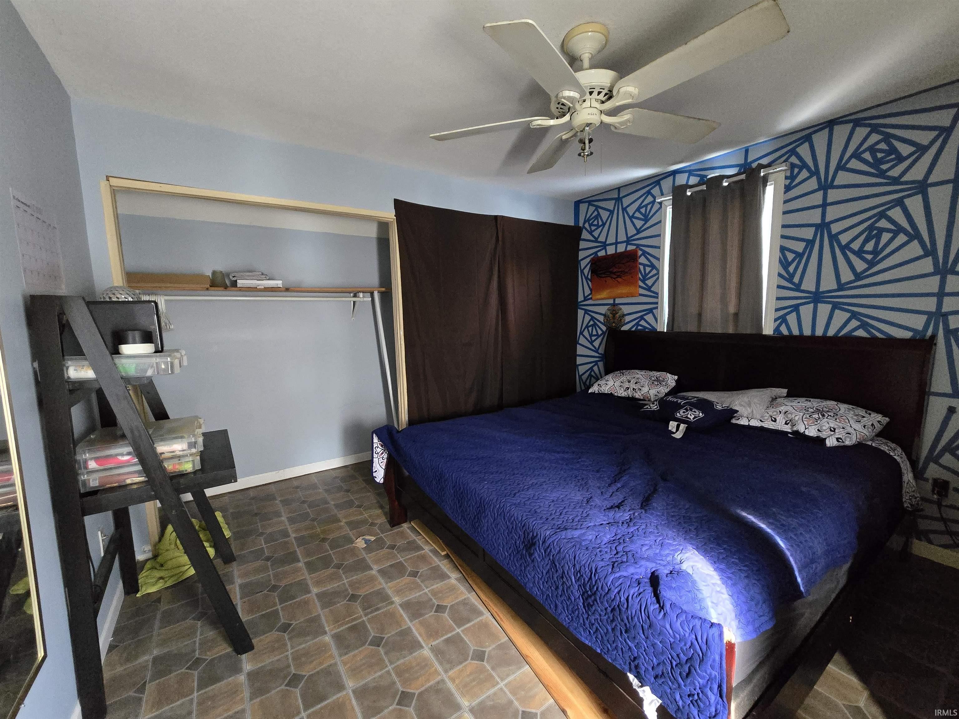 Bedroom featuring a ceiling fan and a closet