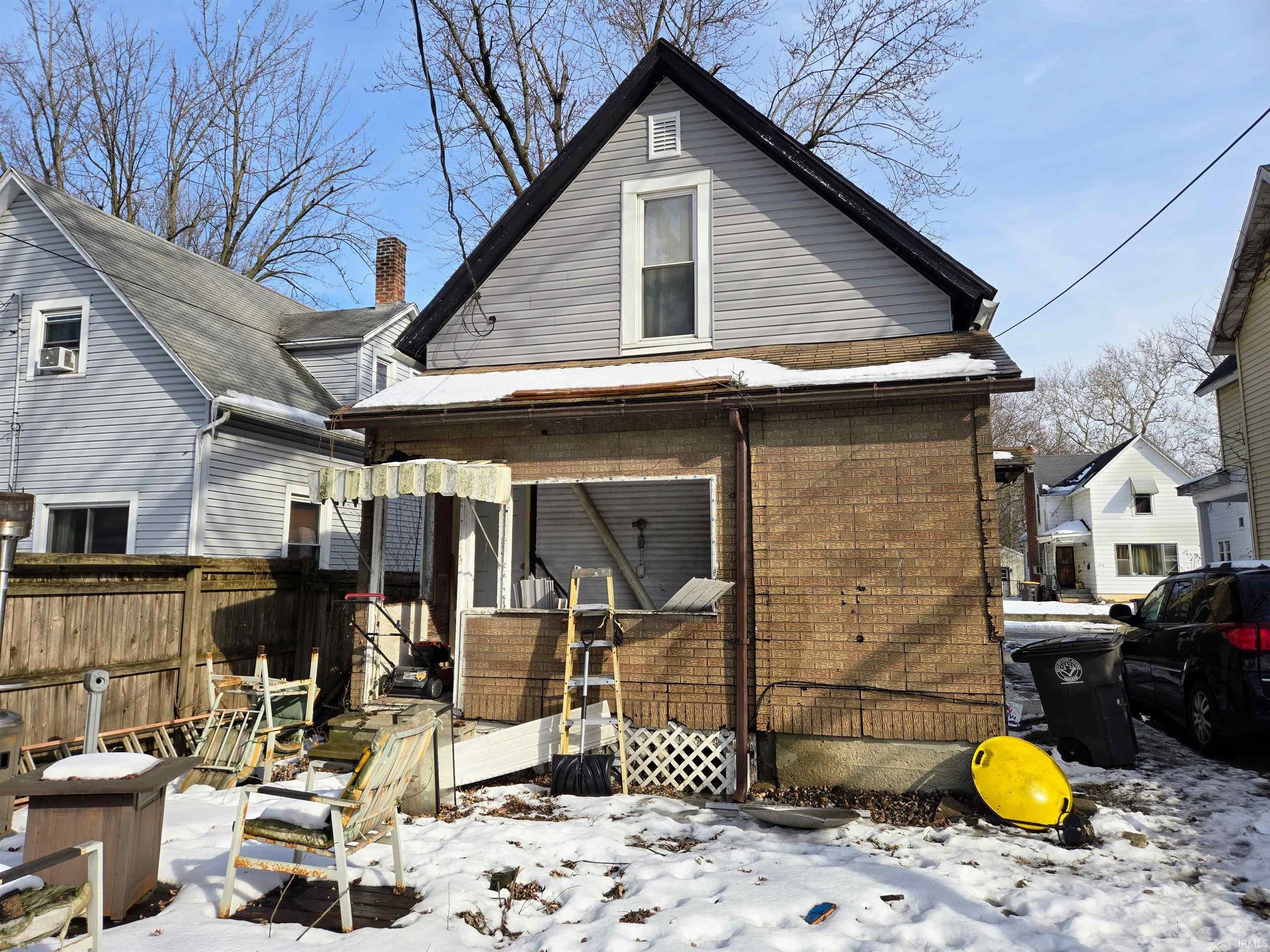 View of snow covered back of property