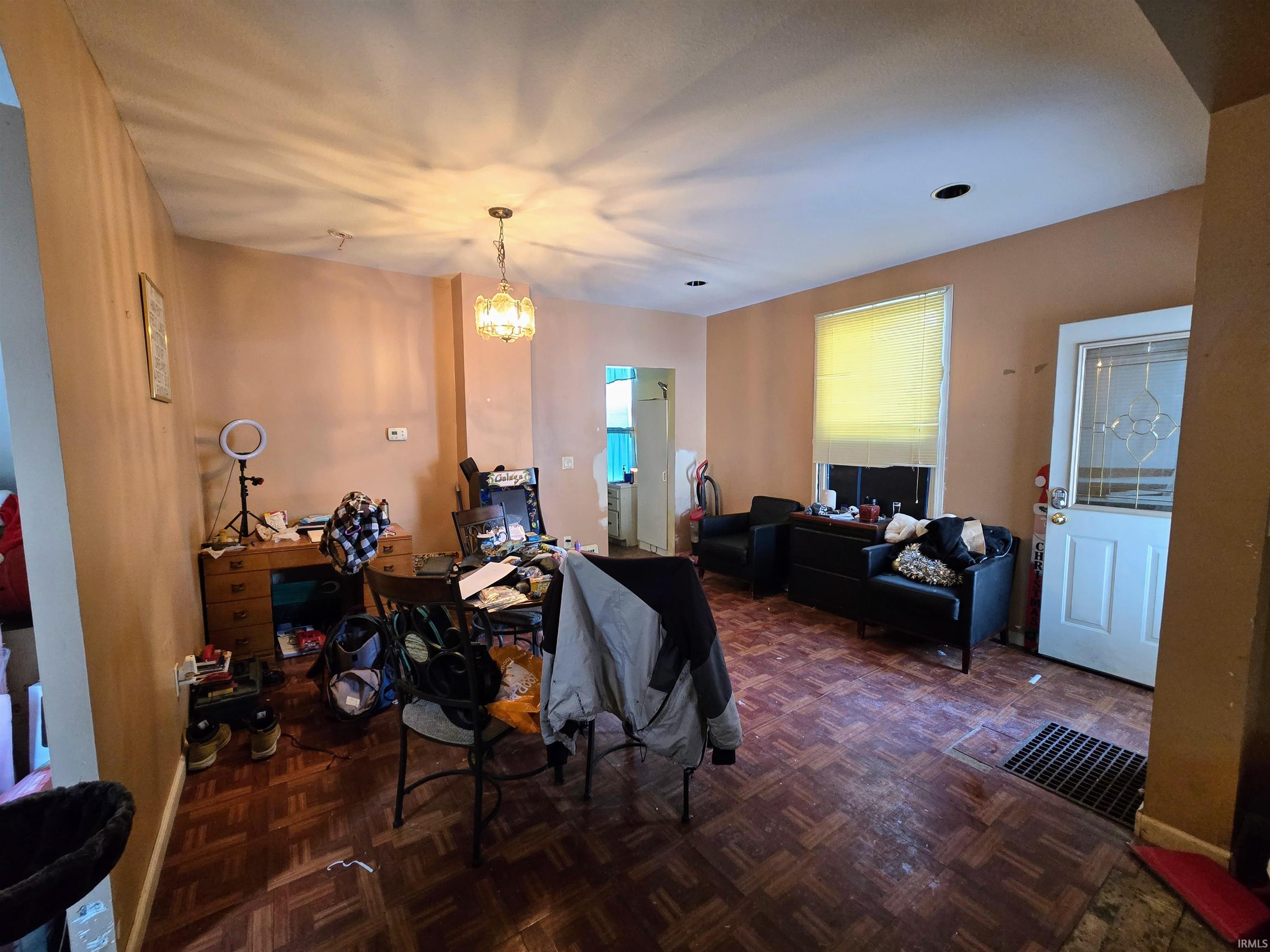 Living room featuring parquet flooring and hanging lights