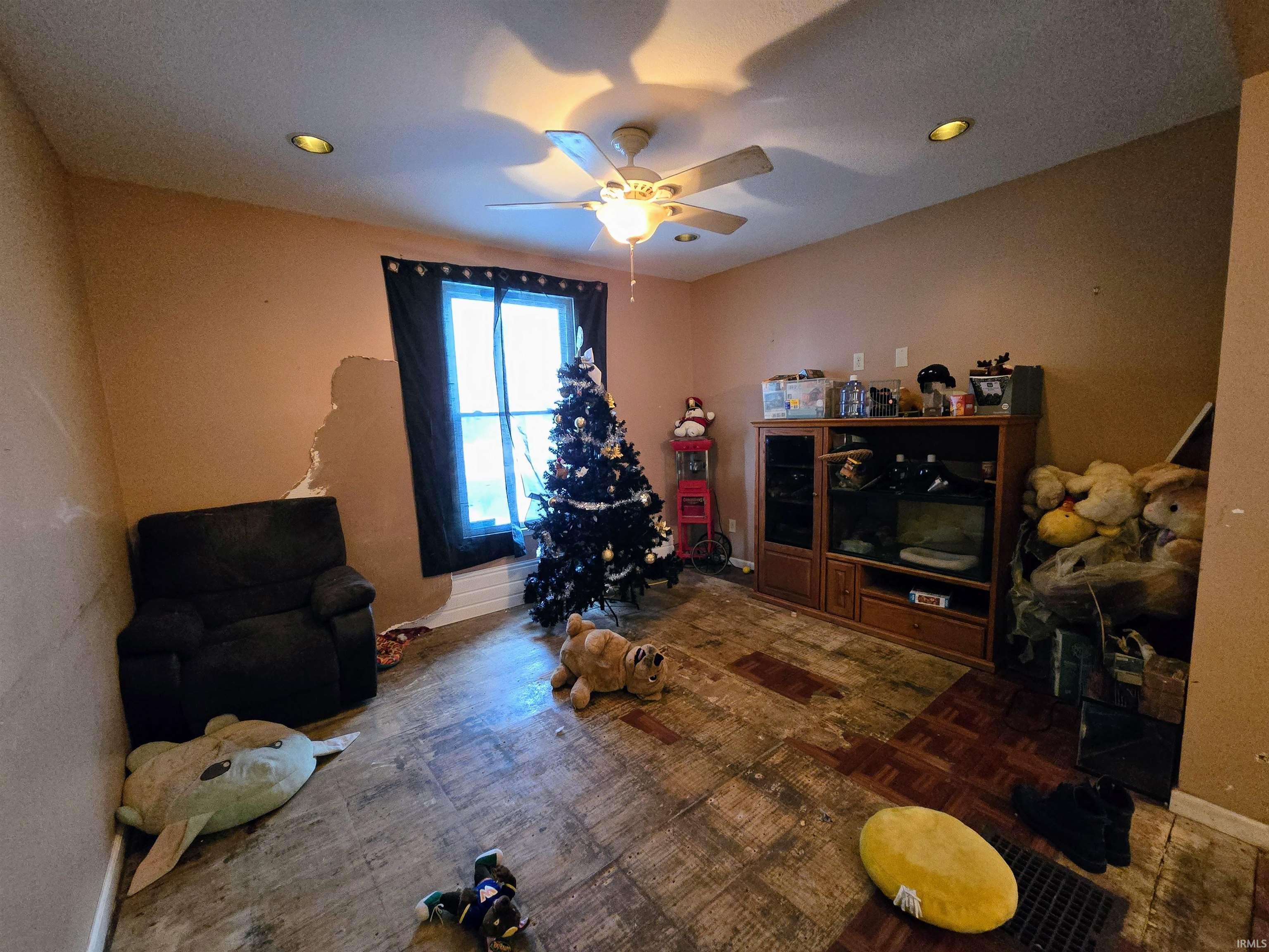 Recreation room featuring a ceiling fan, parquet flooring, and recessed lighting