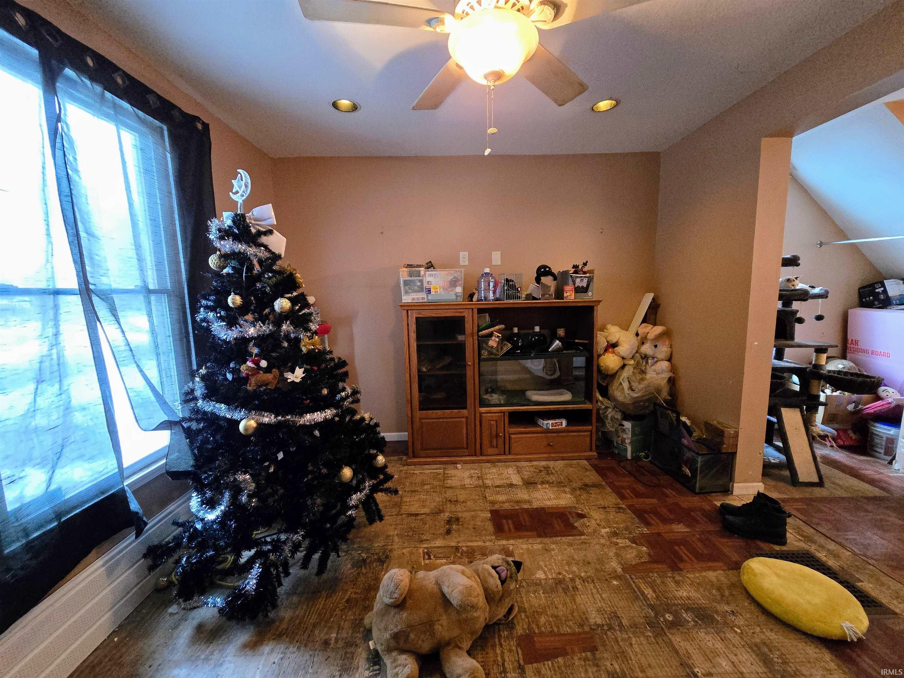Dining space featuring ceiling fan and parquet floors