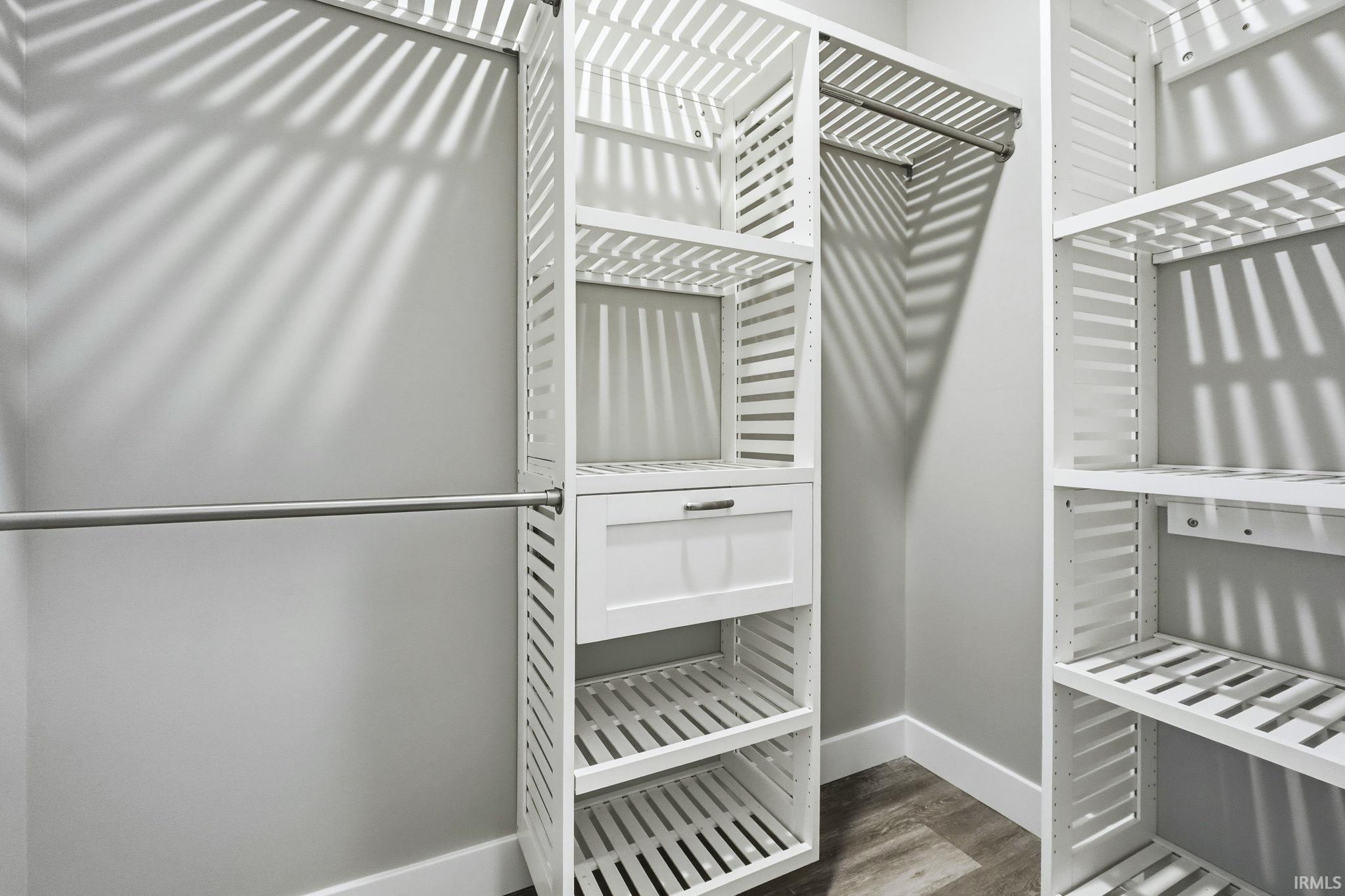 Walk in closet featuring wood finished floors