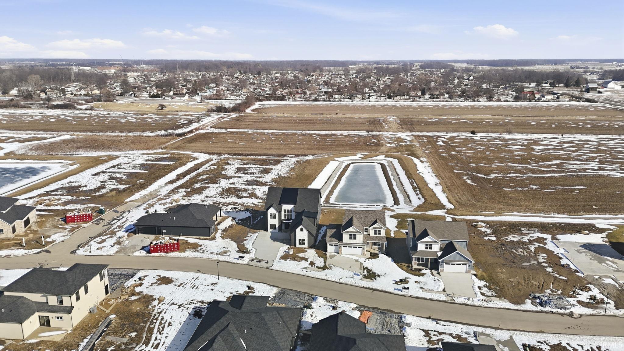 Snowy aerial view featuring a residential view