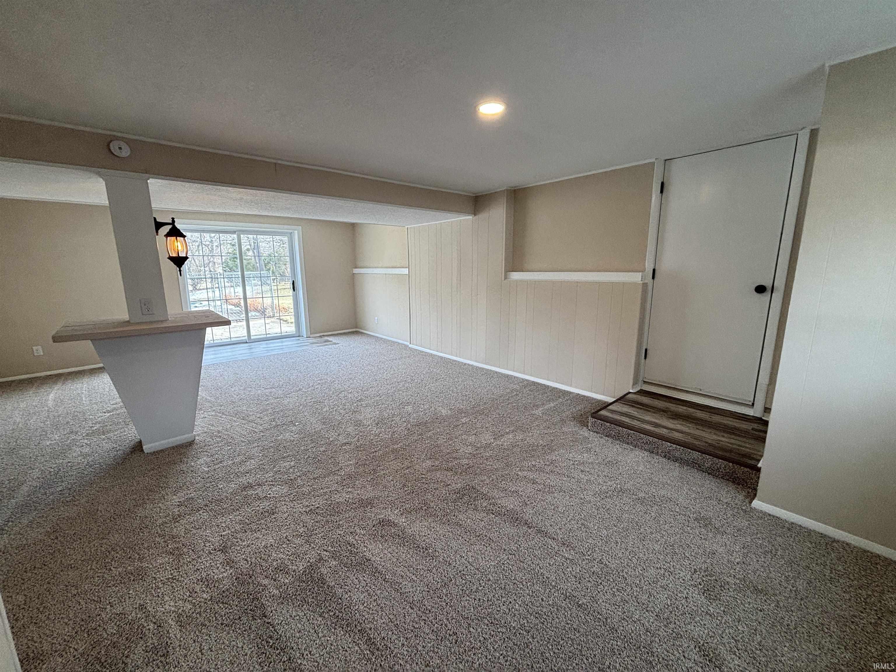 Carpeted empty room featuring baseboards and recessed lighting