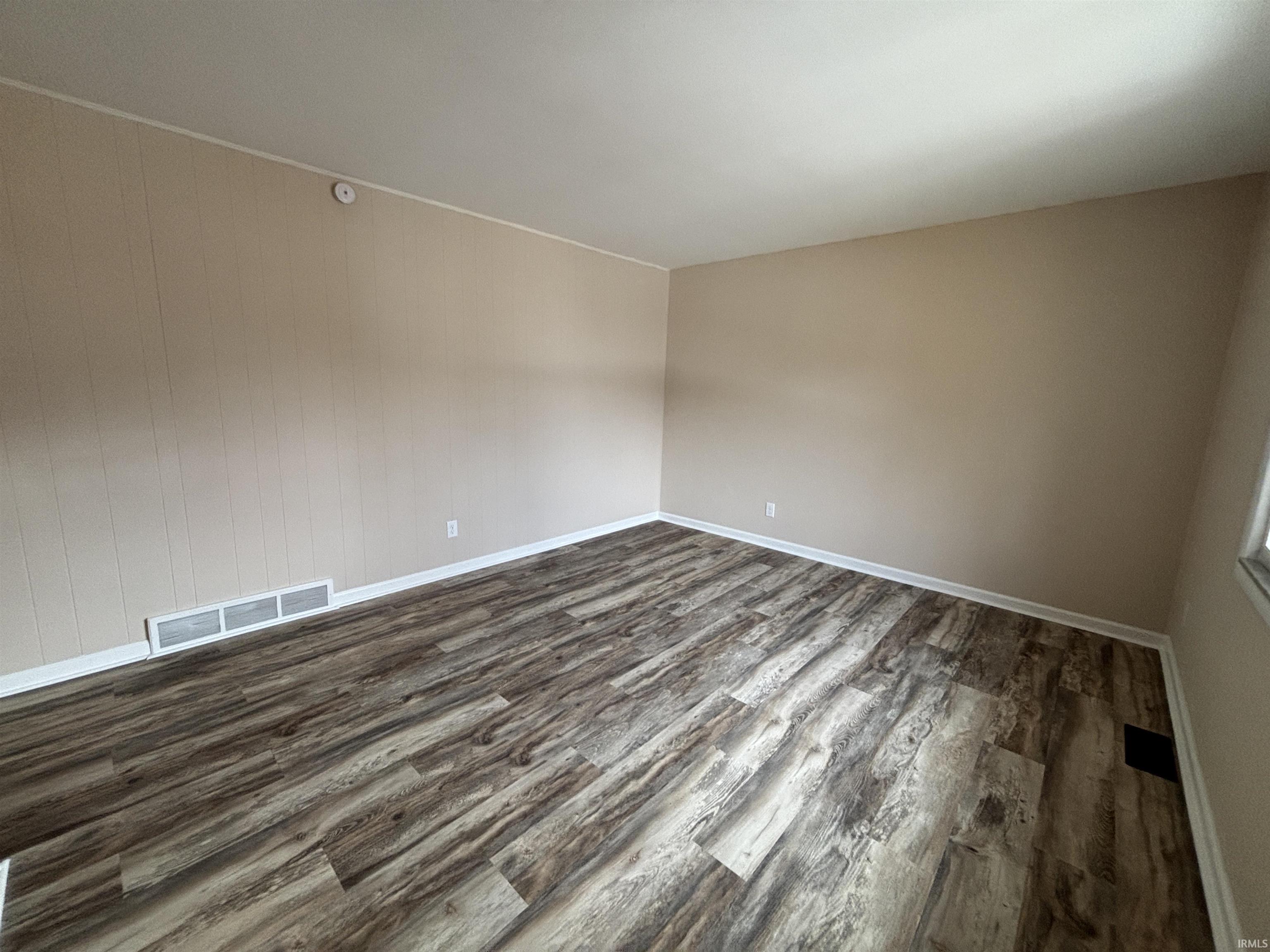 room featuring wood finished floors and wood walls