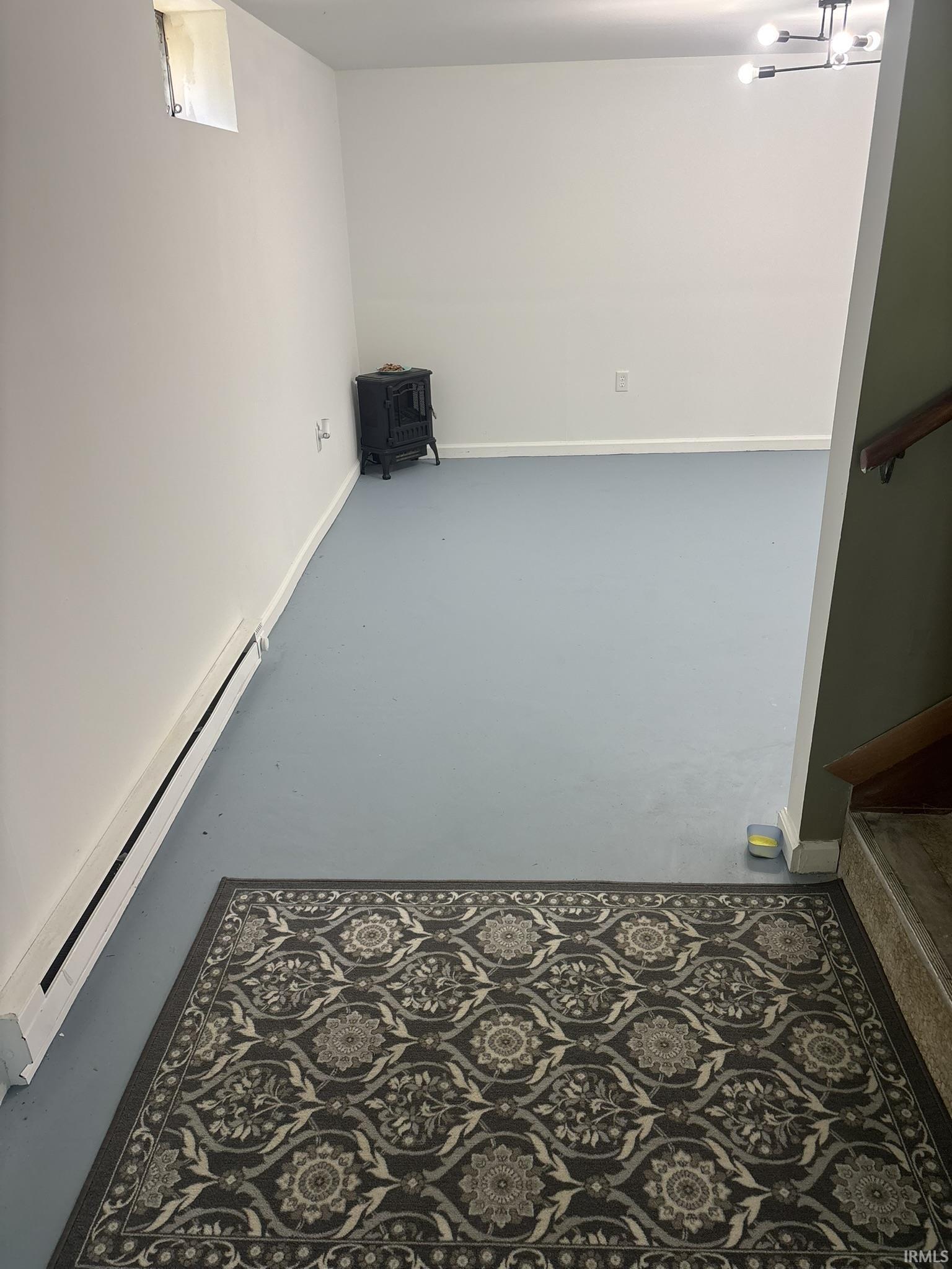 Spacious room featuring light blue flooring and white painted walls