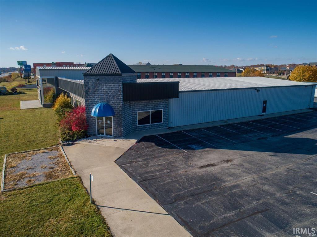 View of property featuring uncovered parking