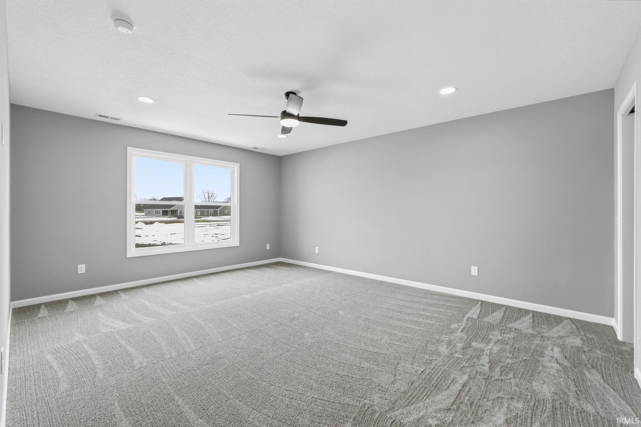 Unfurnished room featuring carpet flooring, ceiling fan, and recessed lighting