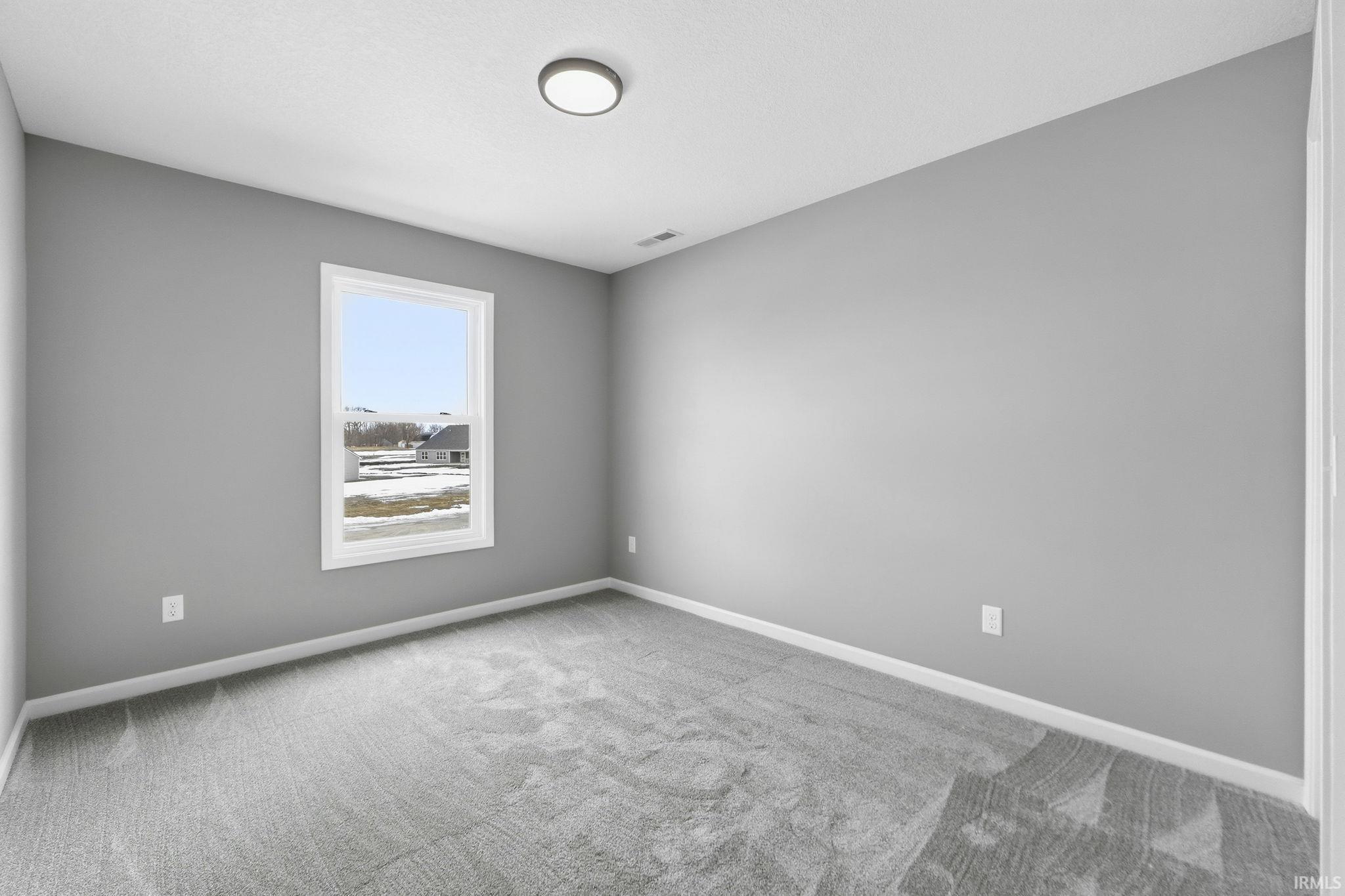 Empty room with baseboards and carpet