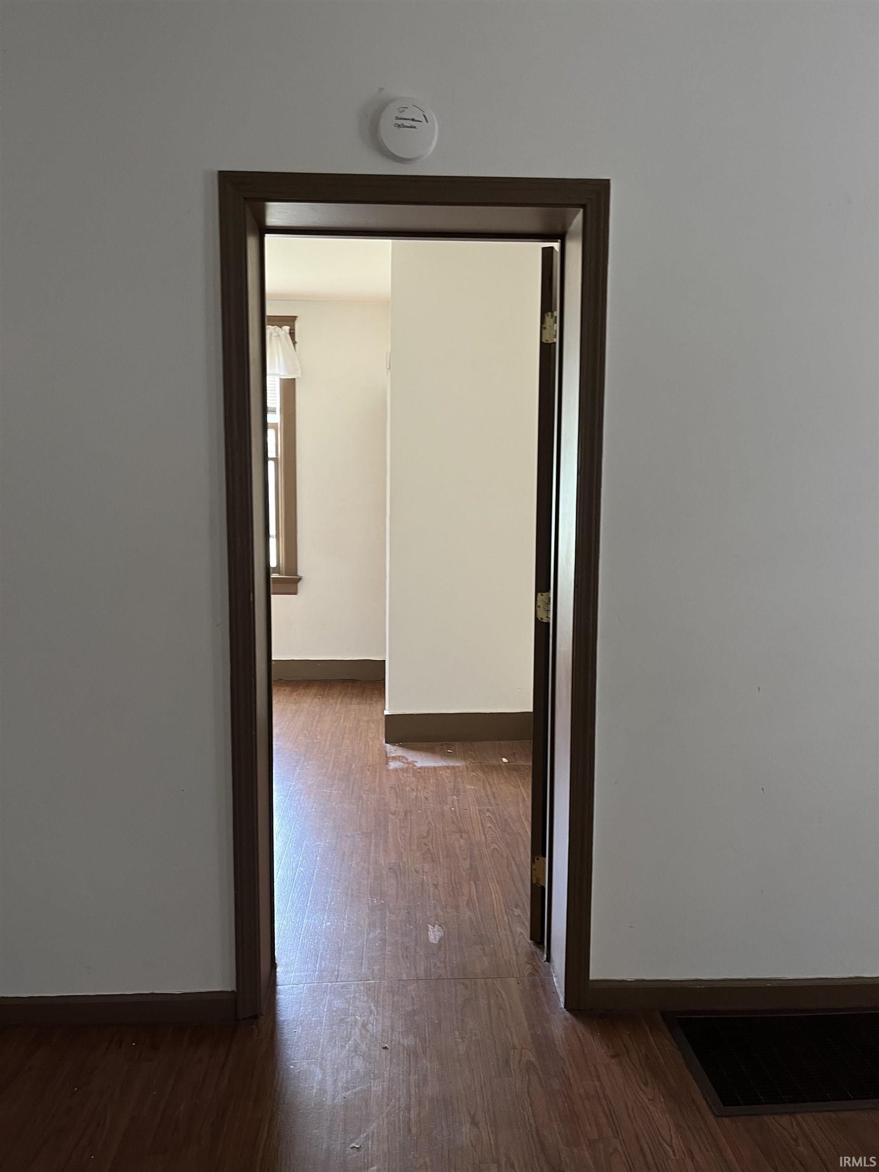 Hallway with baseboards and dark wood-style flooring