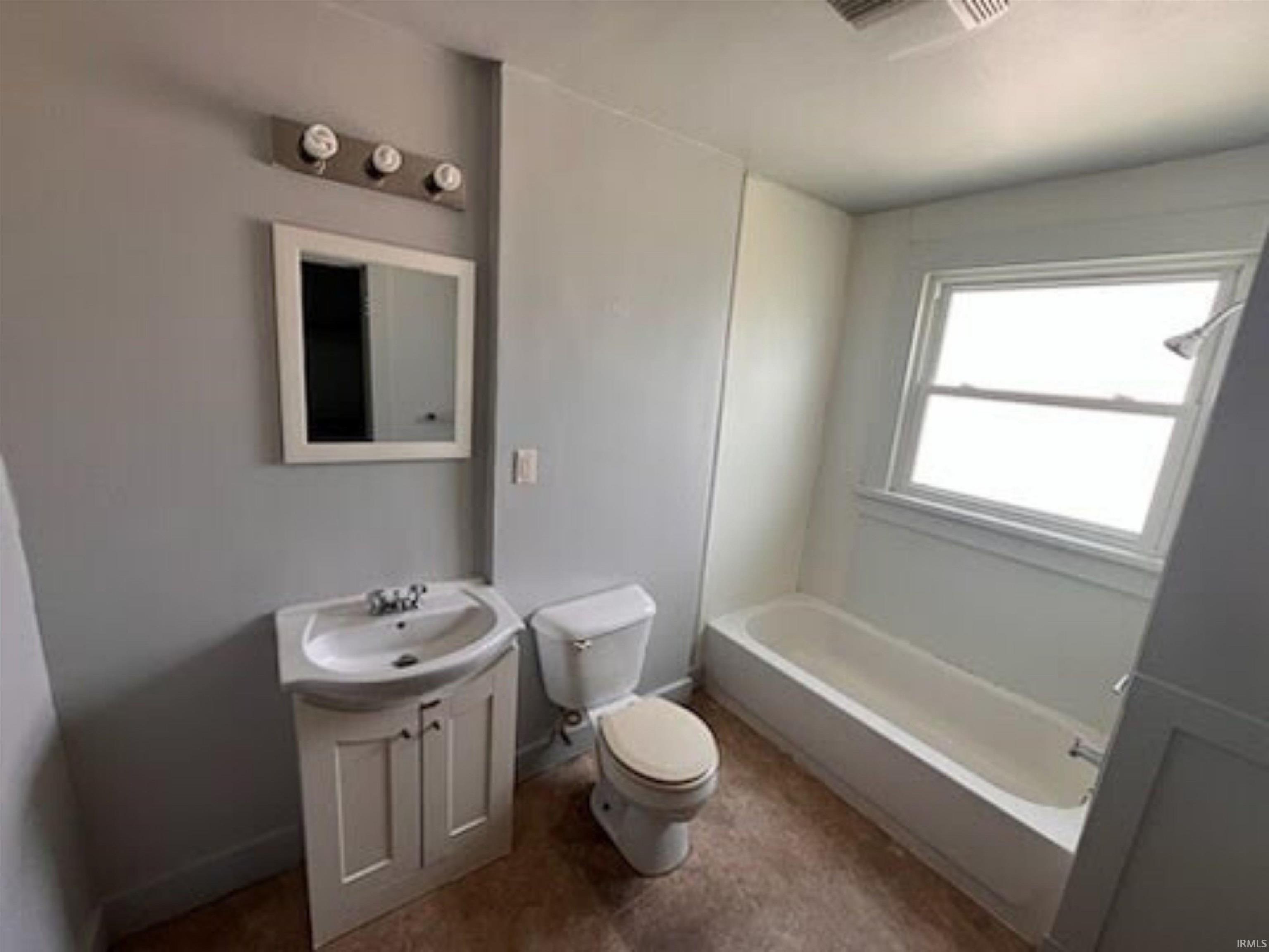 Bathroom featuring vanity and shower / bathtub combination