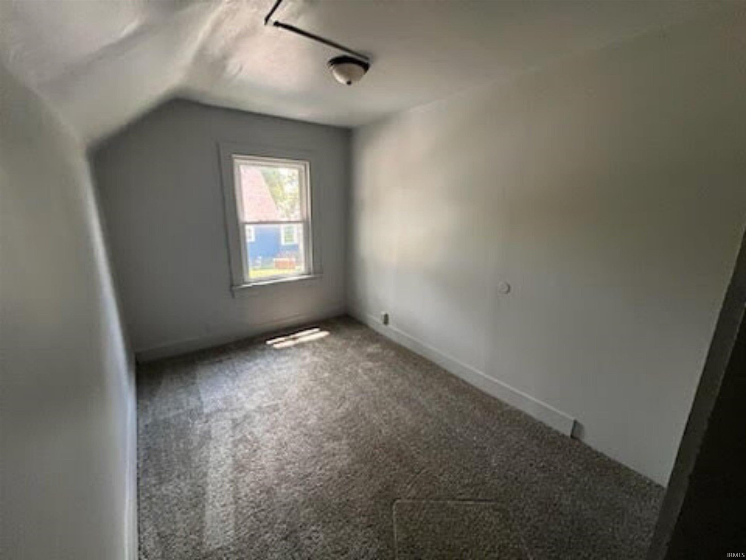 Additional living space with lofted ceiling and carpet