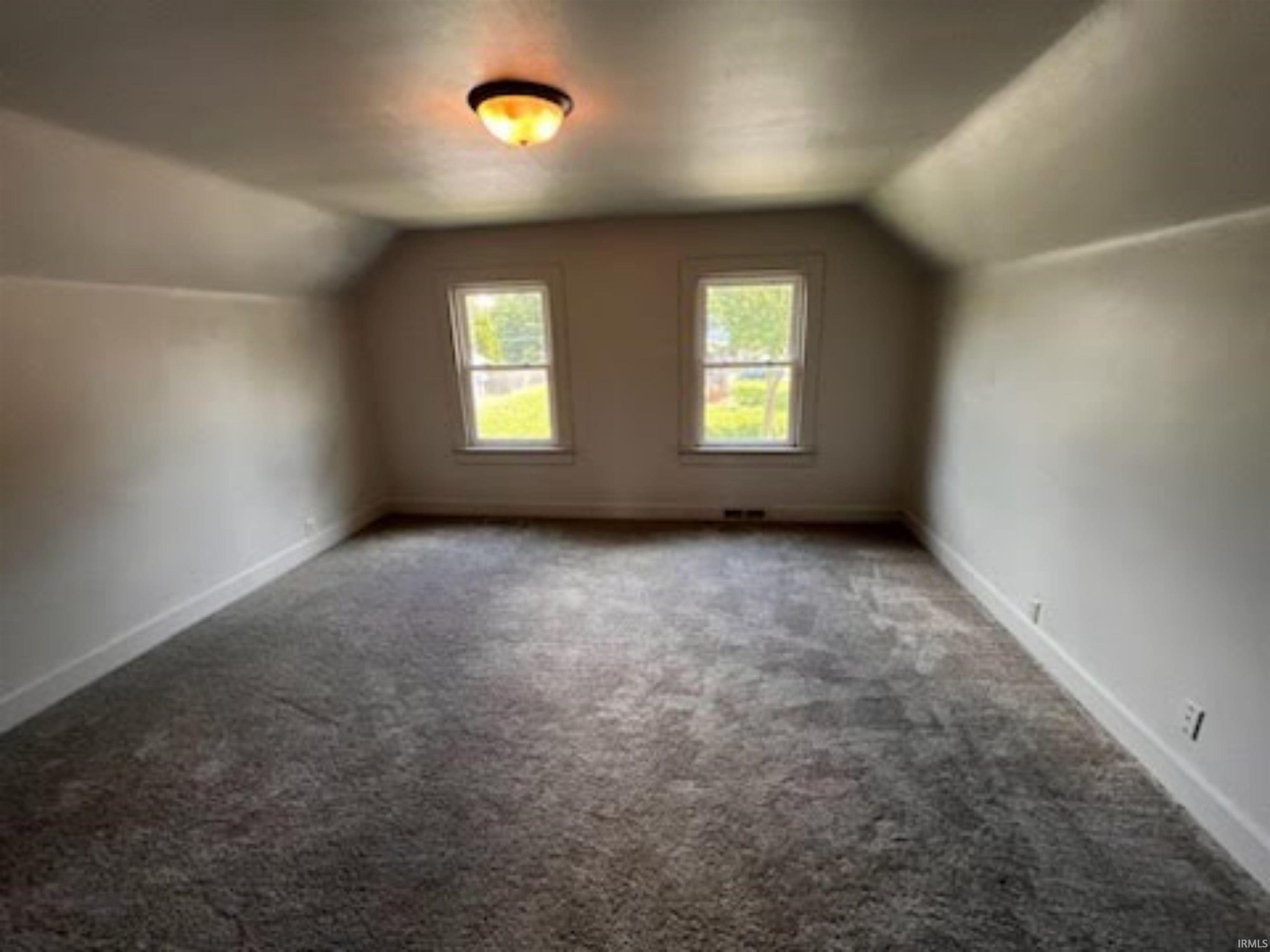 Bonus room with carpet floors and baseboards