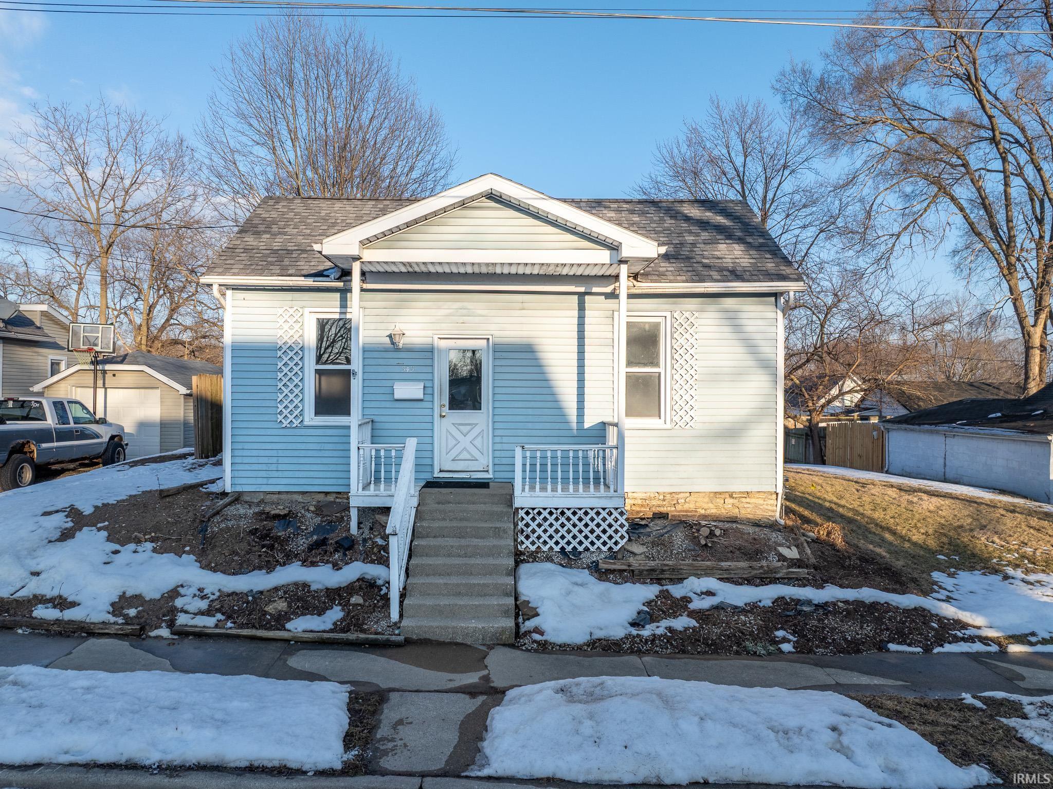 View of front of house with roof with shingles