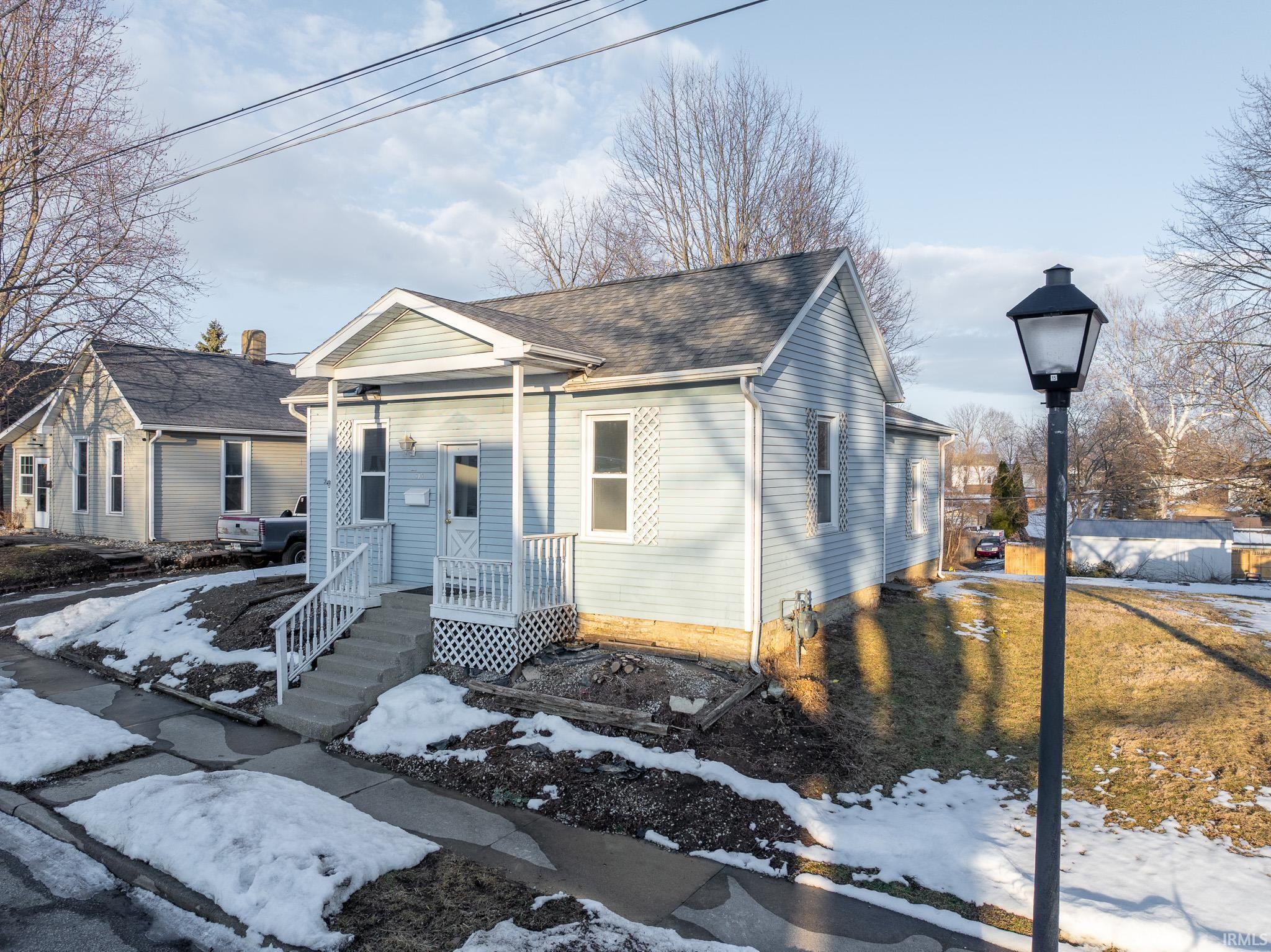 View of front of home with roof with shingles