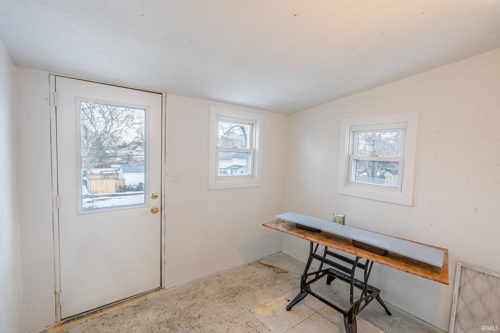 Entryway with plenty of natural light and vaulted ceiling