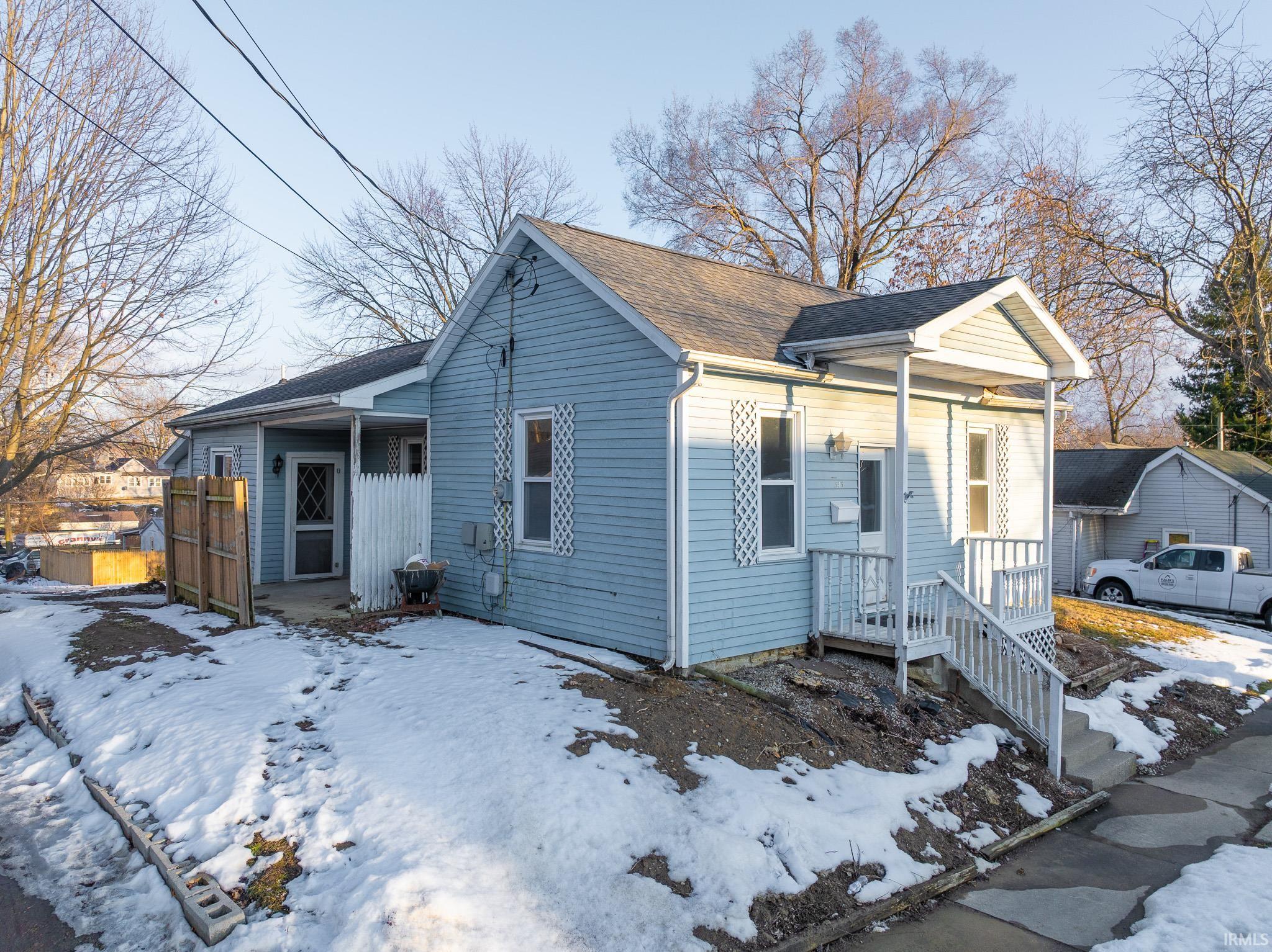 View of front facade featuring roof with shingles