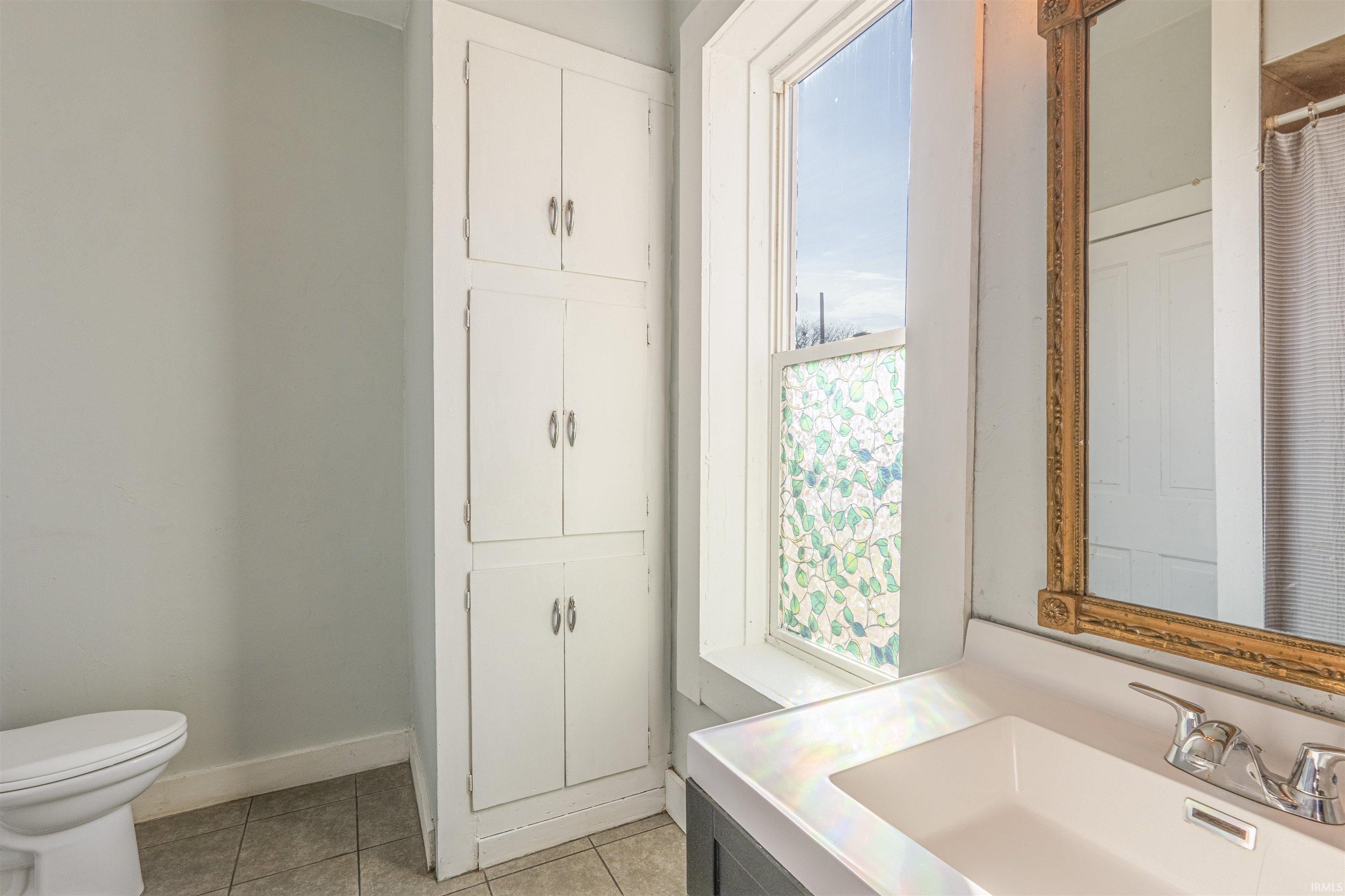Bathroom with vanity and light tile patterned floors