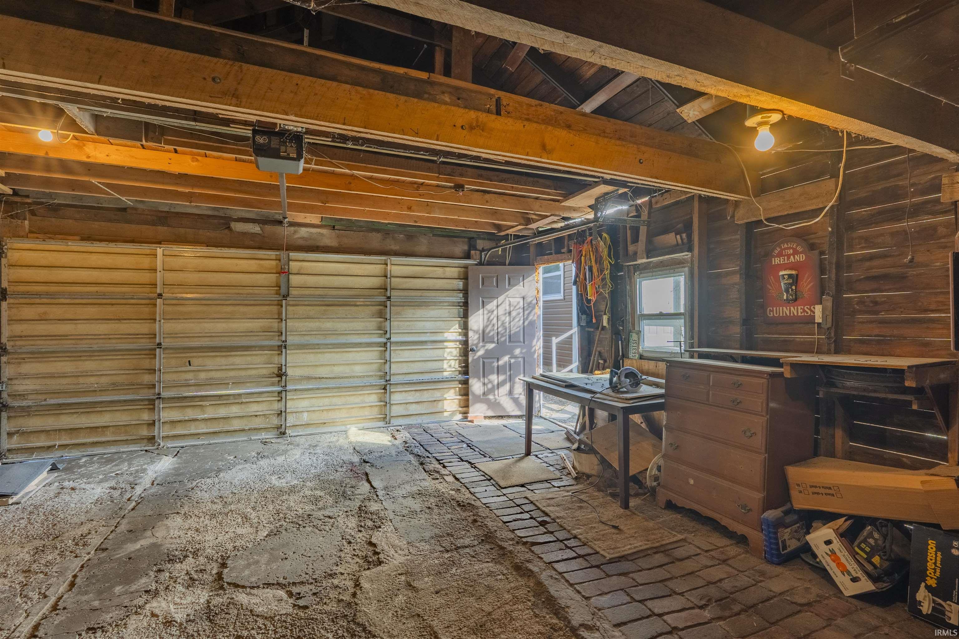 Garage featuring a garage door opener