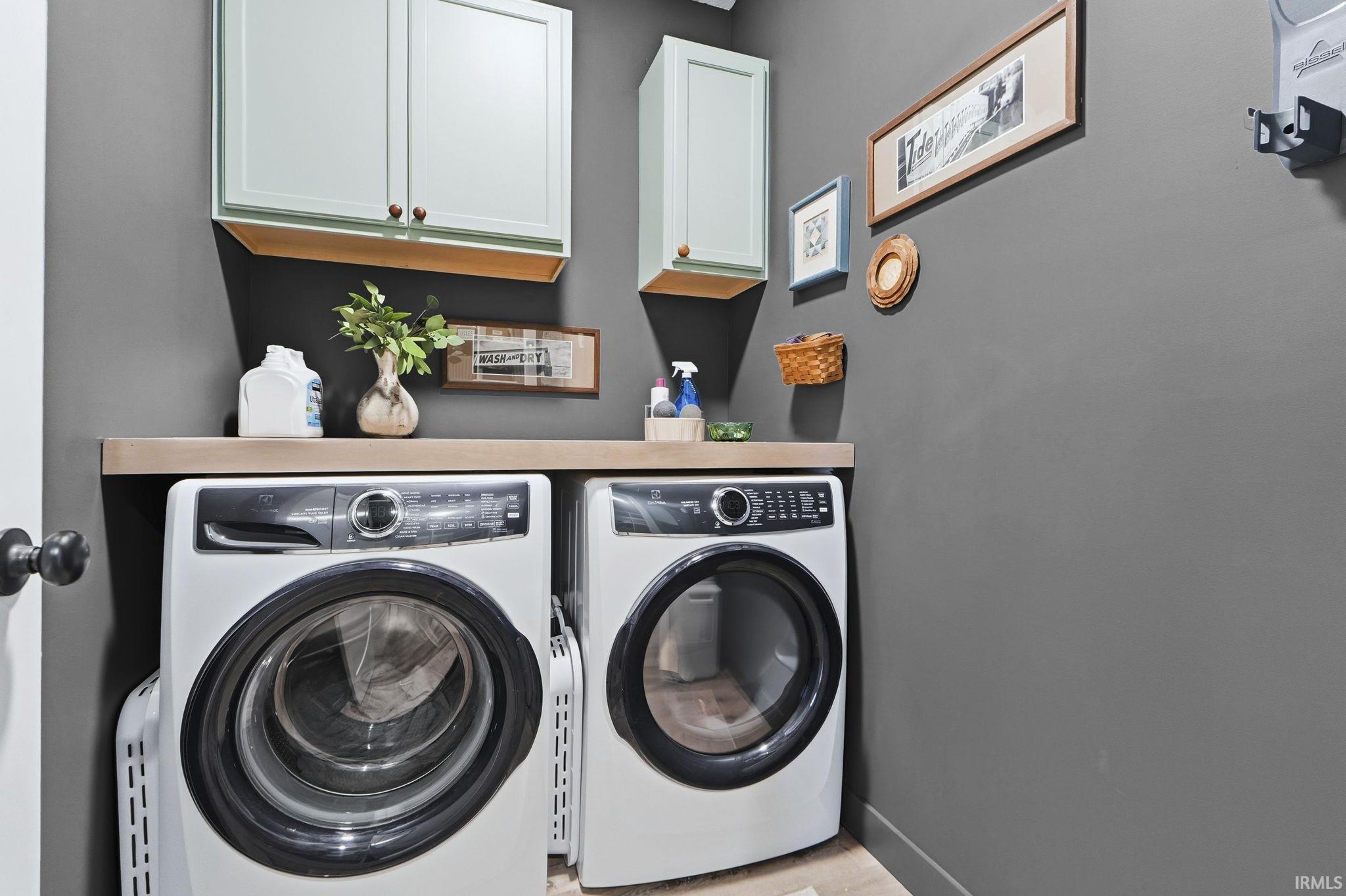 Laundry room featuring cabinet space and washer and dryer