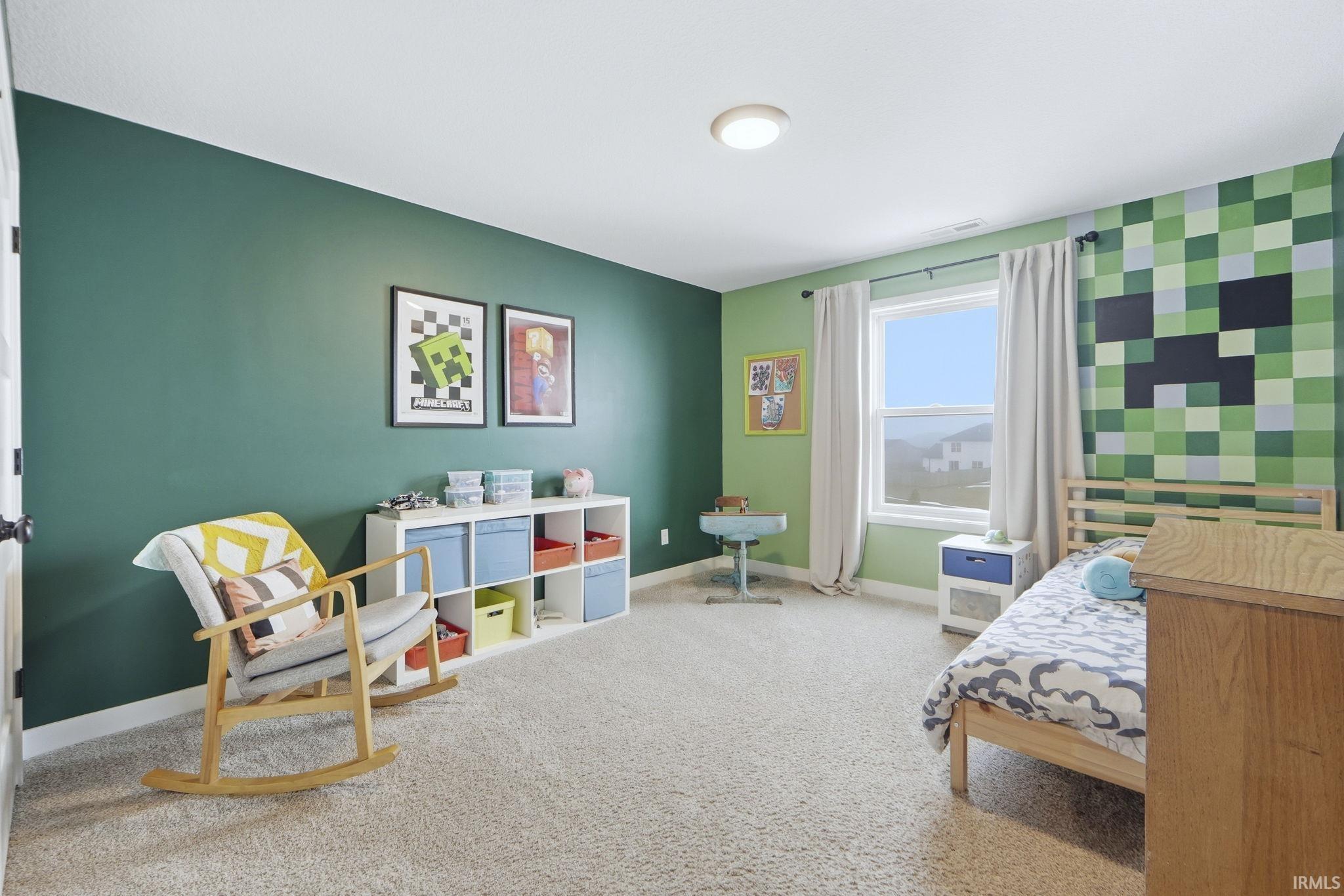 Bedroom featuring an accent wall and carpet flooring