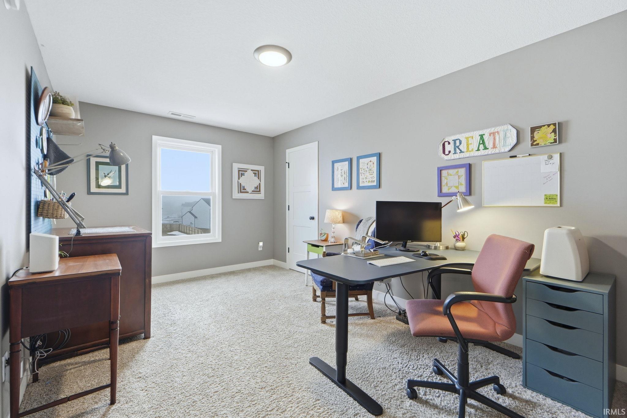 Office space featuring light colored carpet