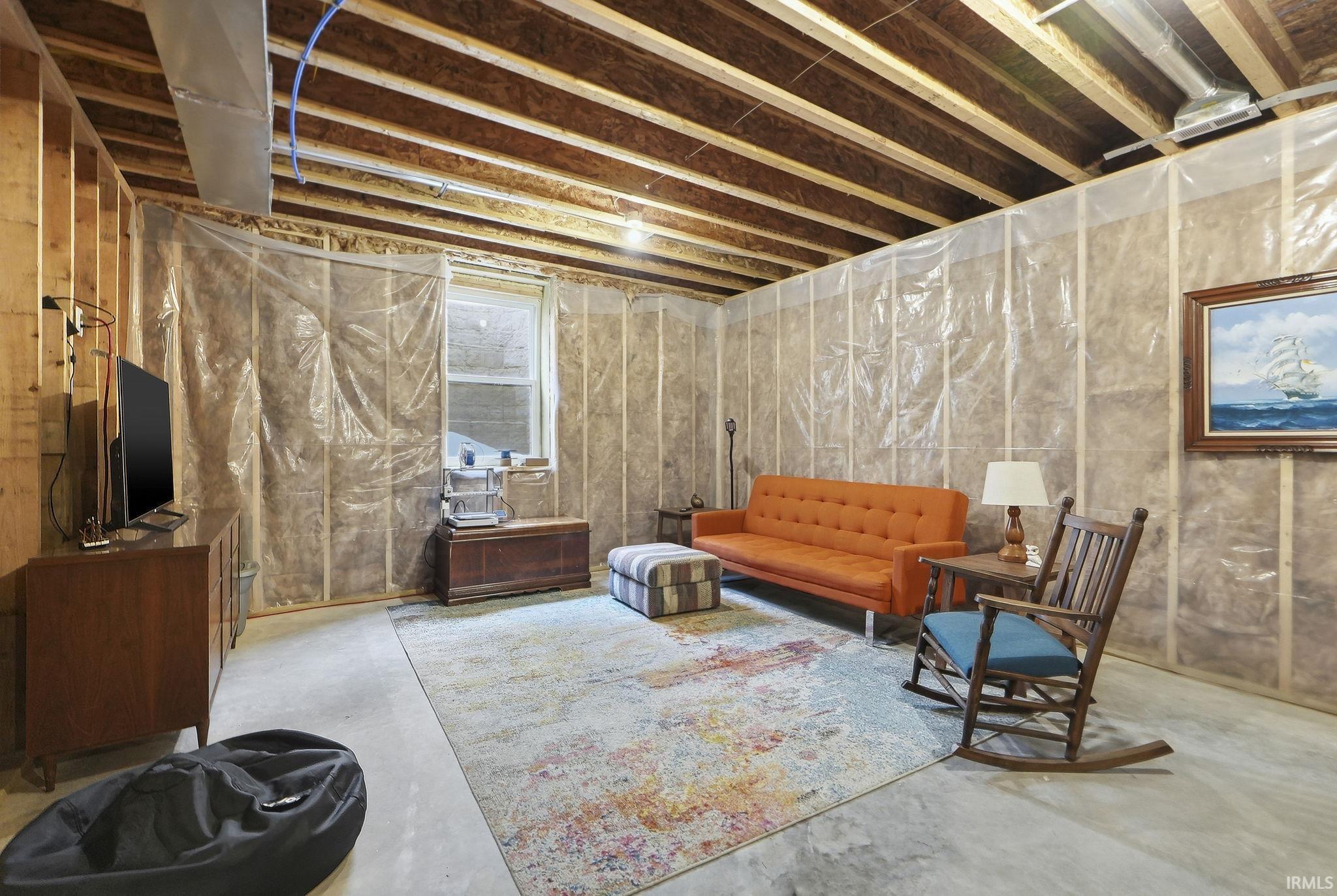 Sitting room with unfinished concrete flooring