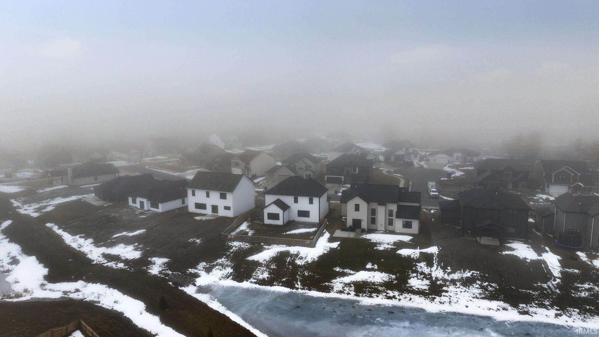 Snowy aerial view featuring a residential view