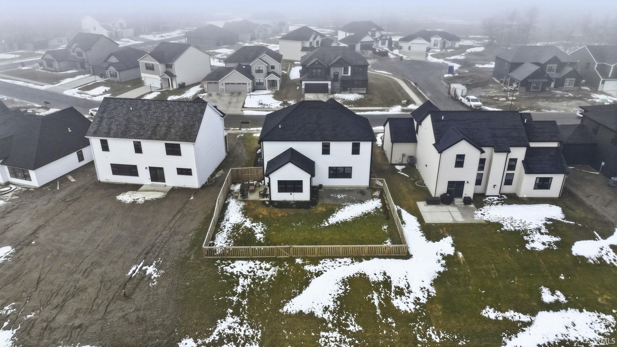 Snowy aerial view featuring a residential view
