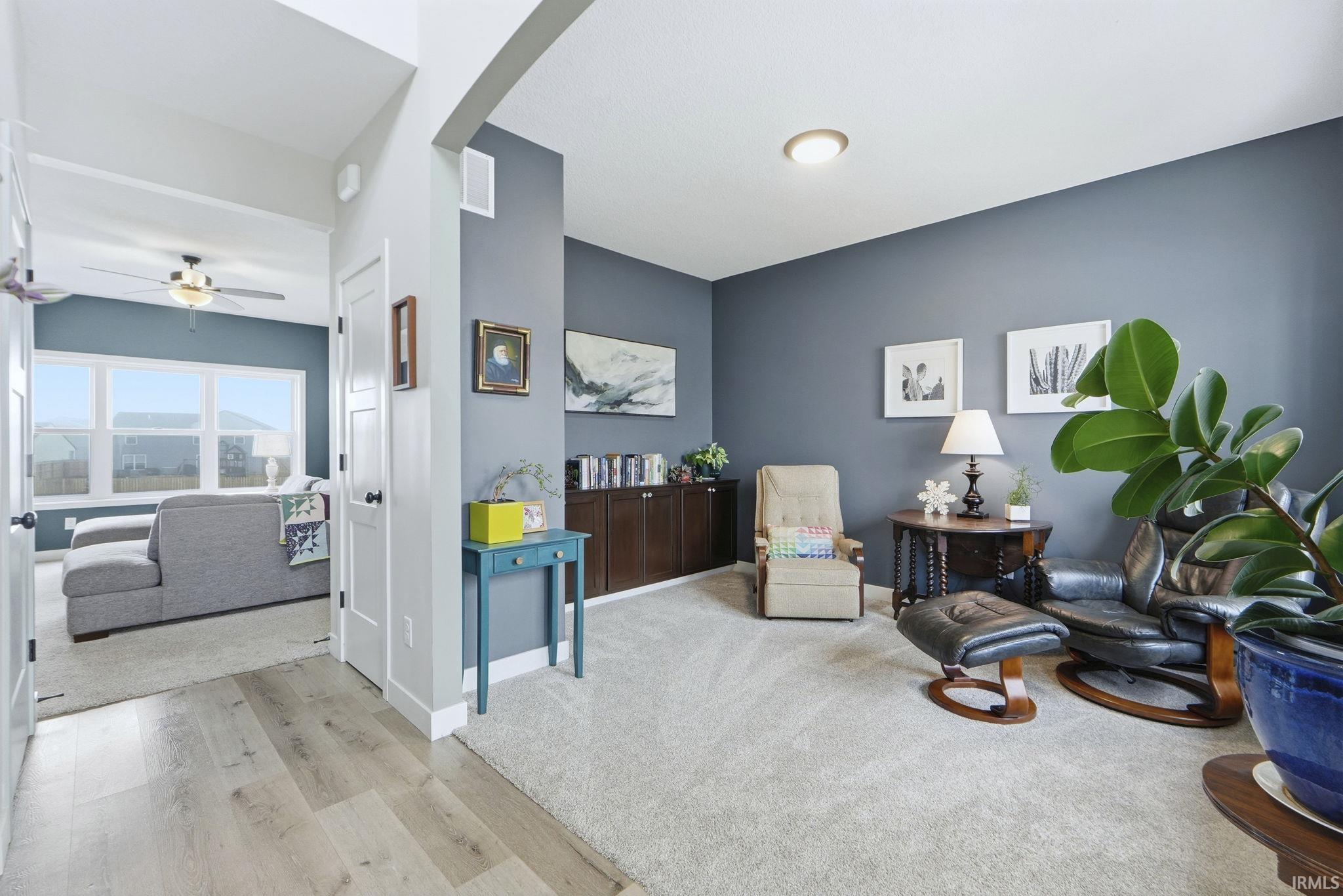 Sitting room featuring a ceiling fan and light wood-style floors