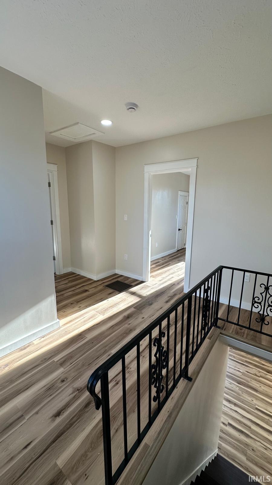 Stairway featuring wood finished floors and baseboards