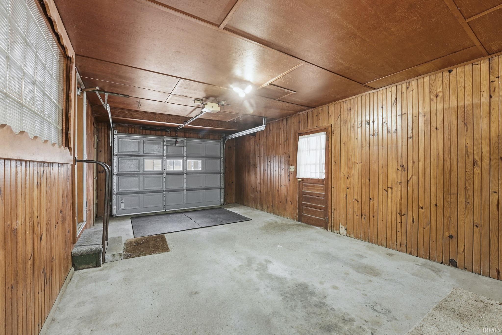 Garage featuring wood walls