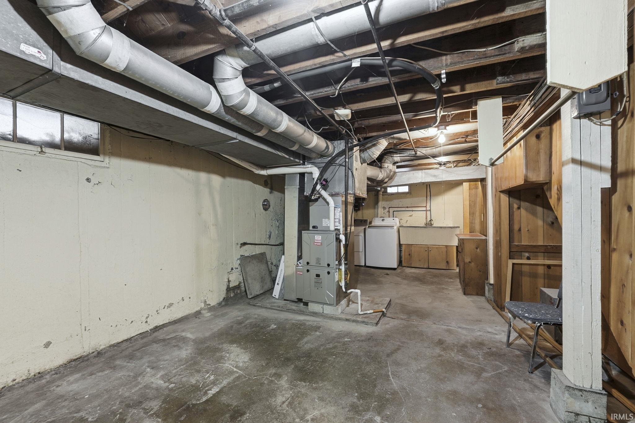 Basement featuring washer / dryer and heating unit
