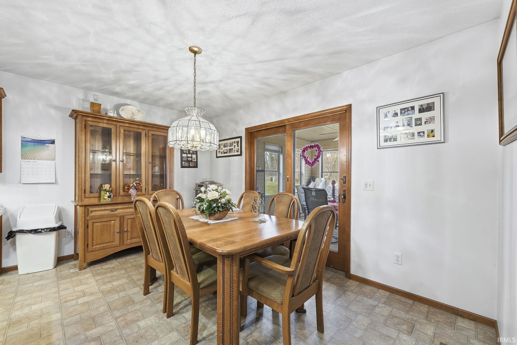 Dining area with stone finish flooring and a chandelier