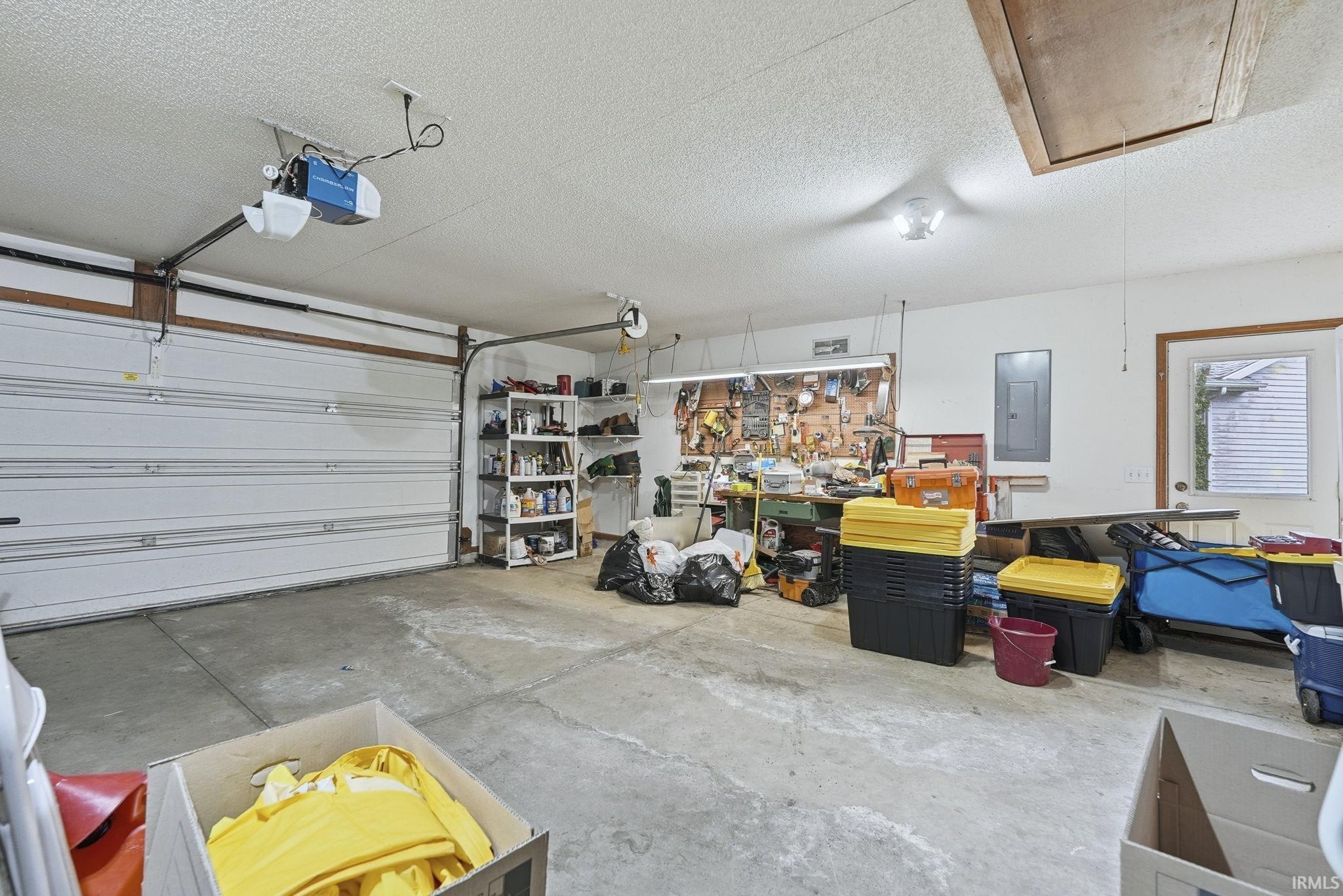 Garage with electric panel and a garage door opener