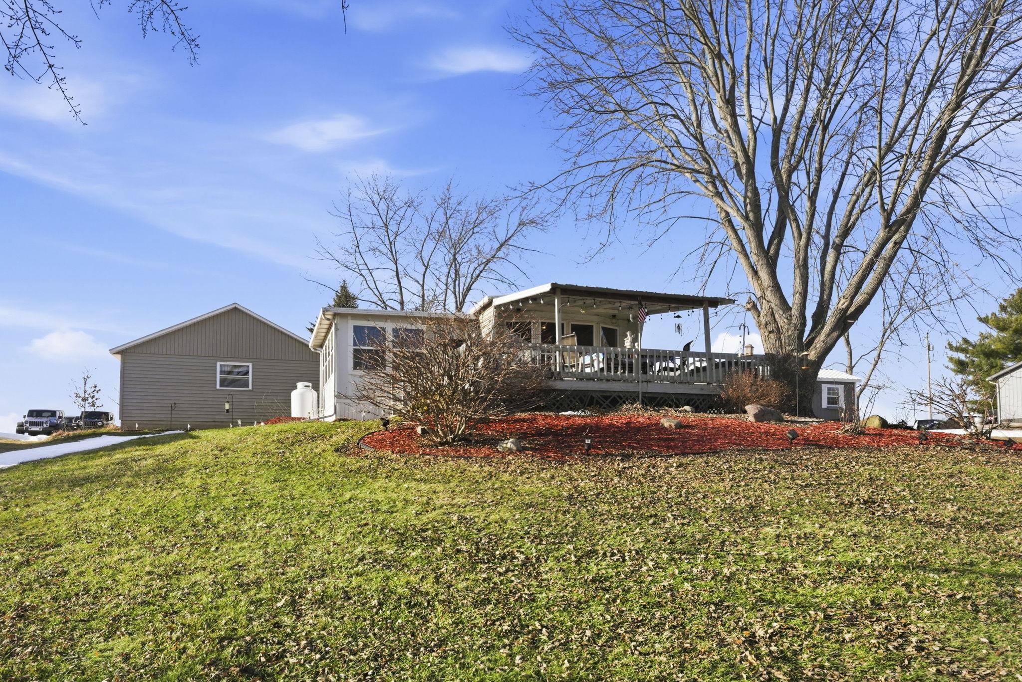 Rear view of property with a wooden deck and a yard