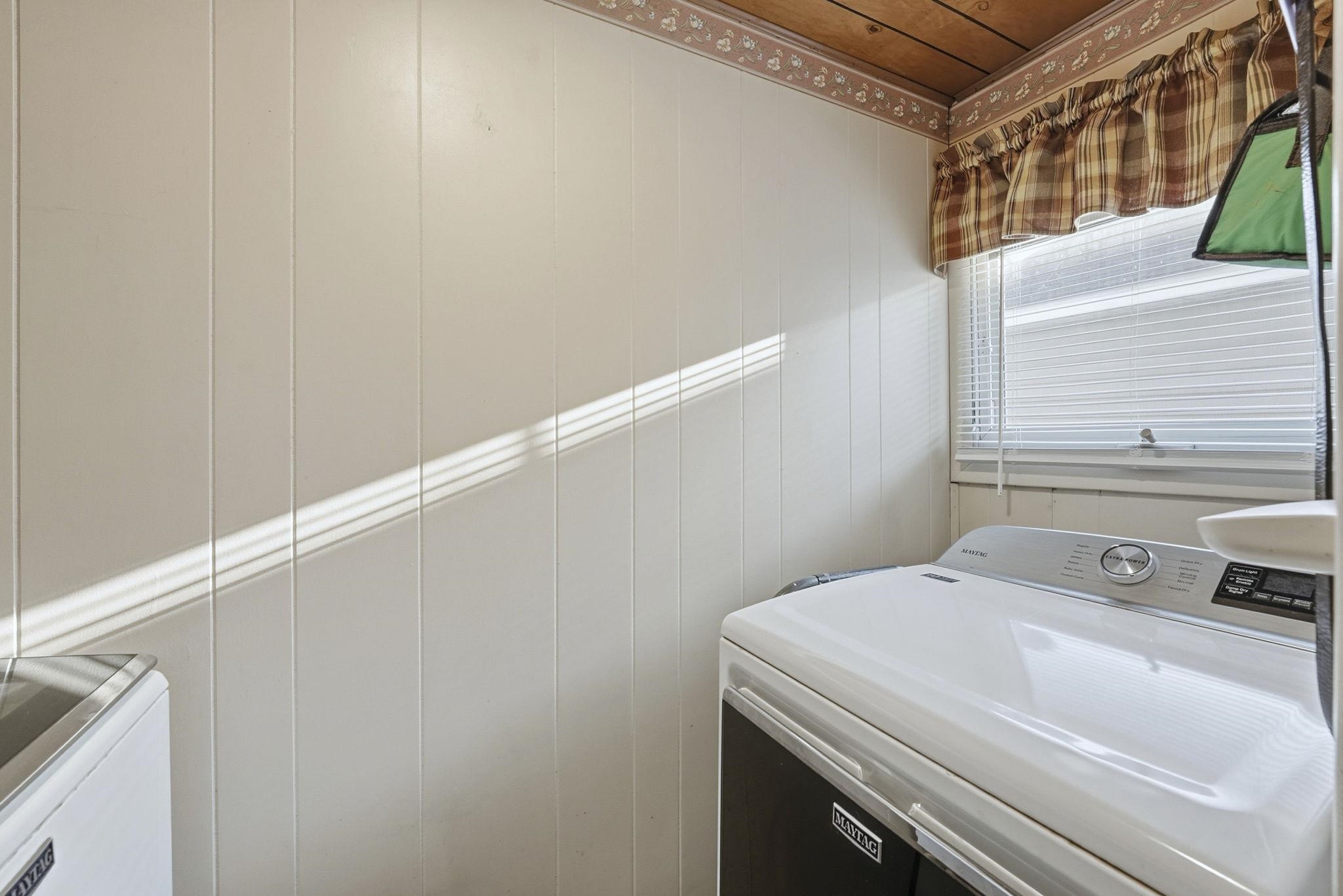 Laundry room with washer and clothes dryer