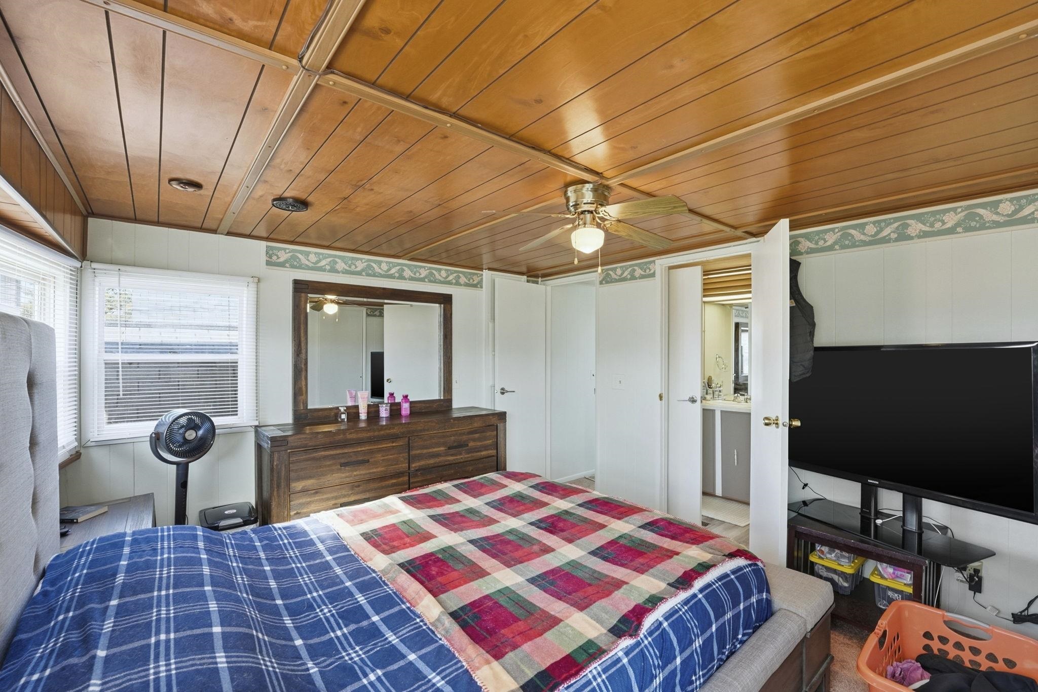 Bedroom featuring wooden ceiling and ceiling fan