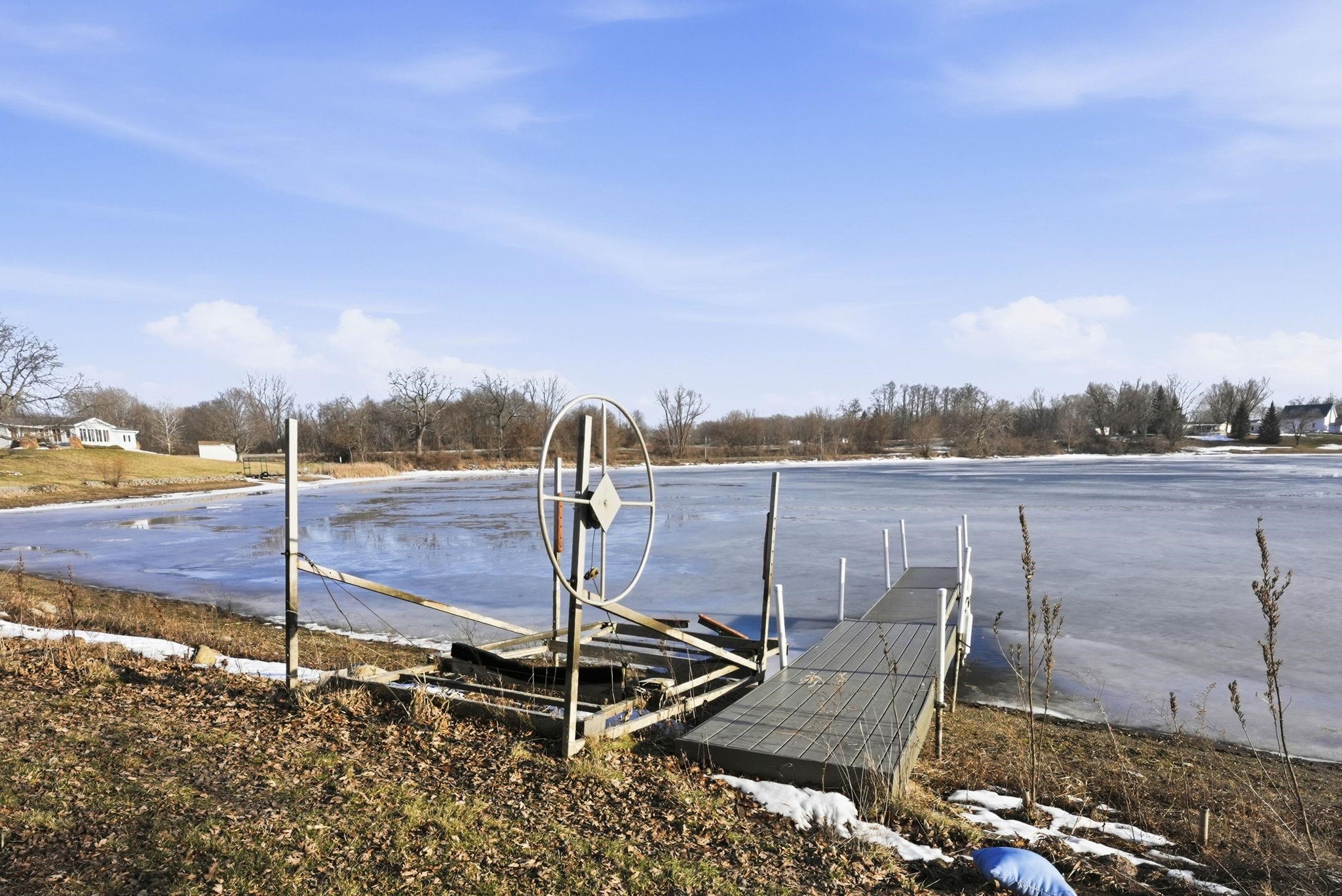 View of pool featuring a boat dock