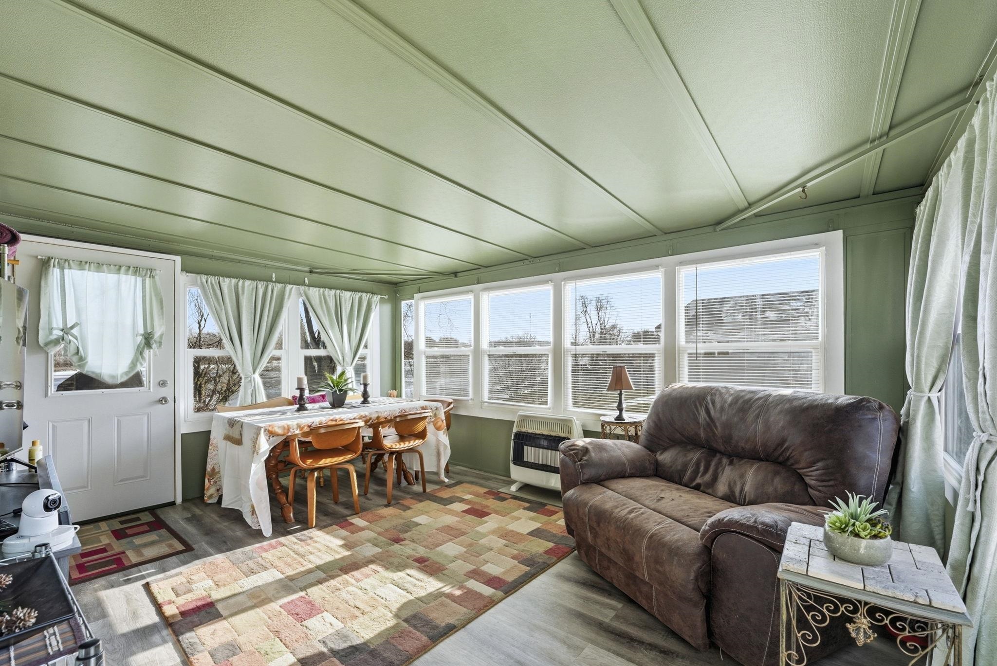 Sunroom / solarium featuring wood finished floors and heating unit