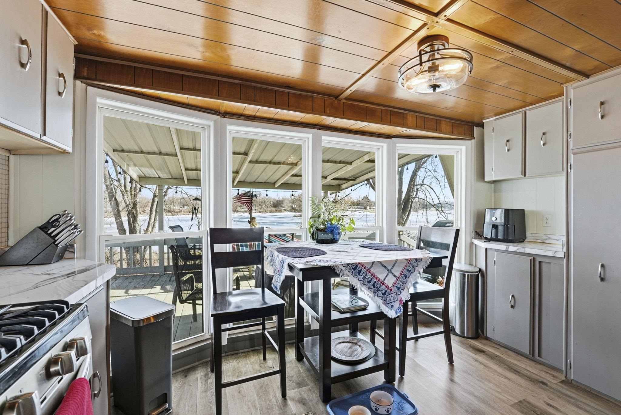 Dining area with light wood finished floors and wooden ceiling