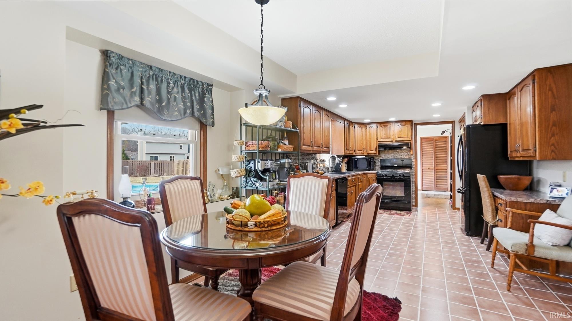 Dining area featuring recessed lighting and light tile patterned flooring