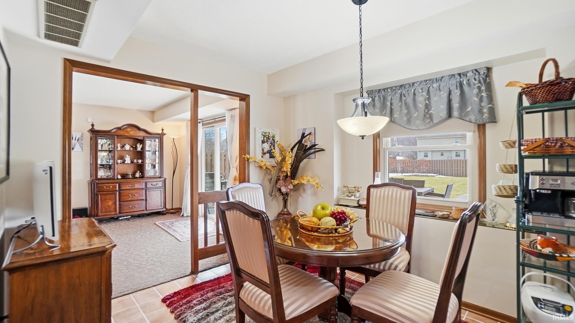 Dining room featuring light colored carpet and light tile patterned floors