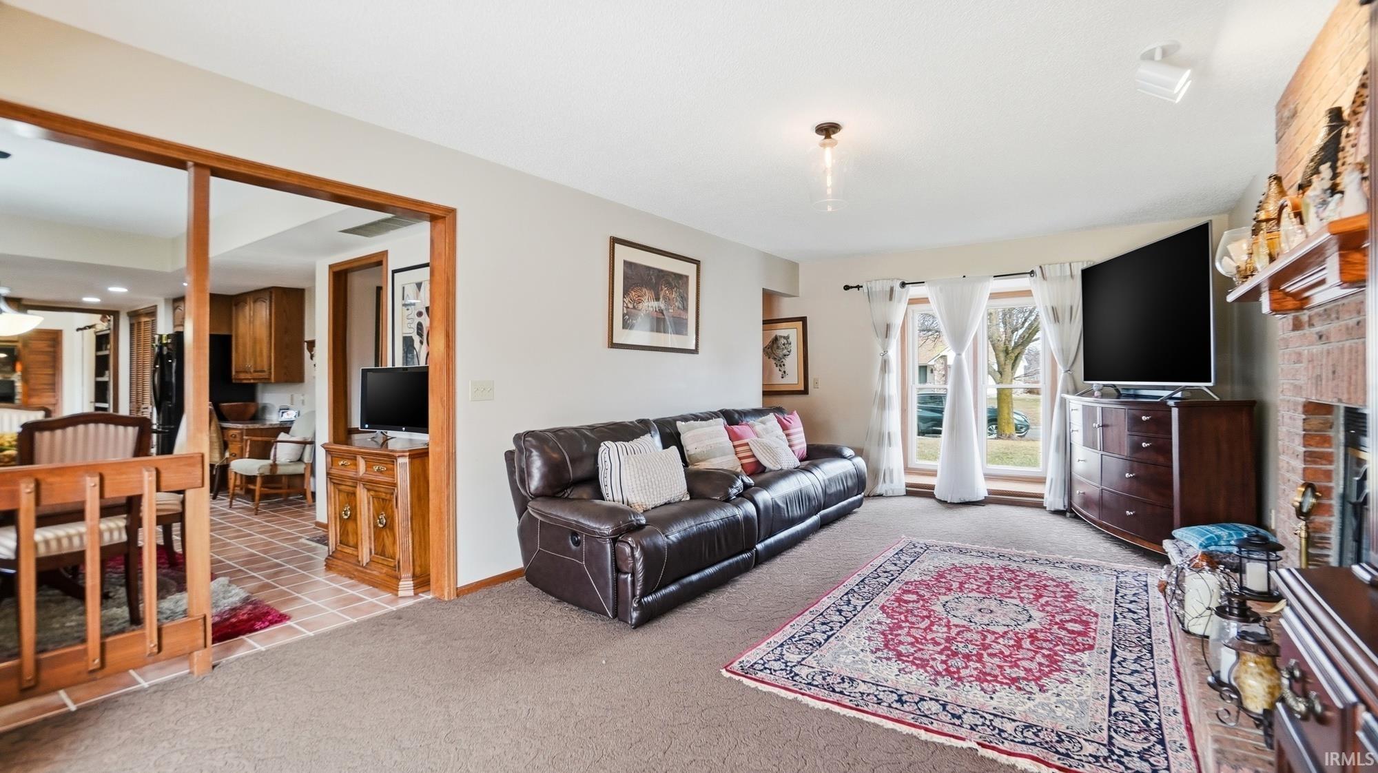 Living room featuring carpet flooring and a fireplace